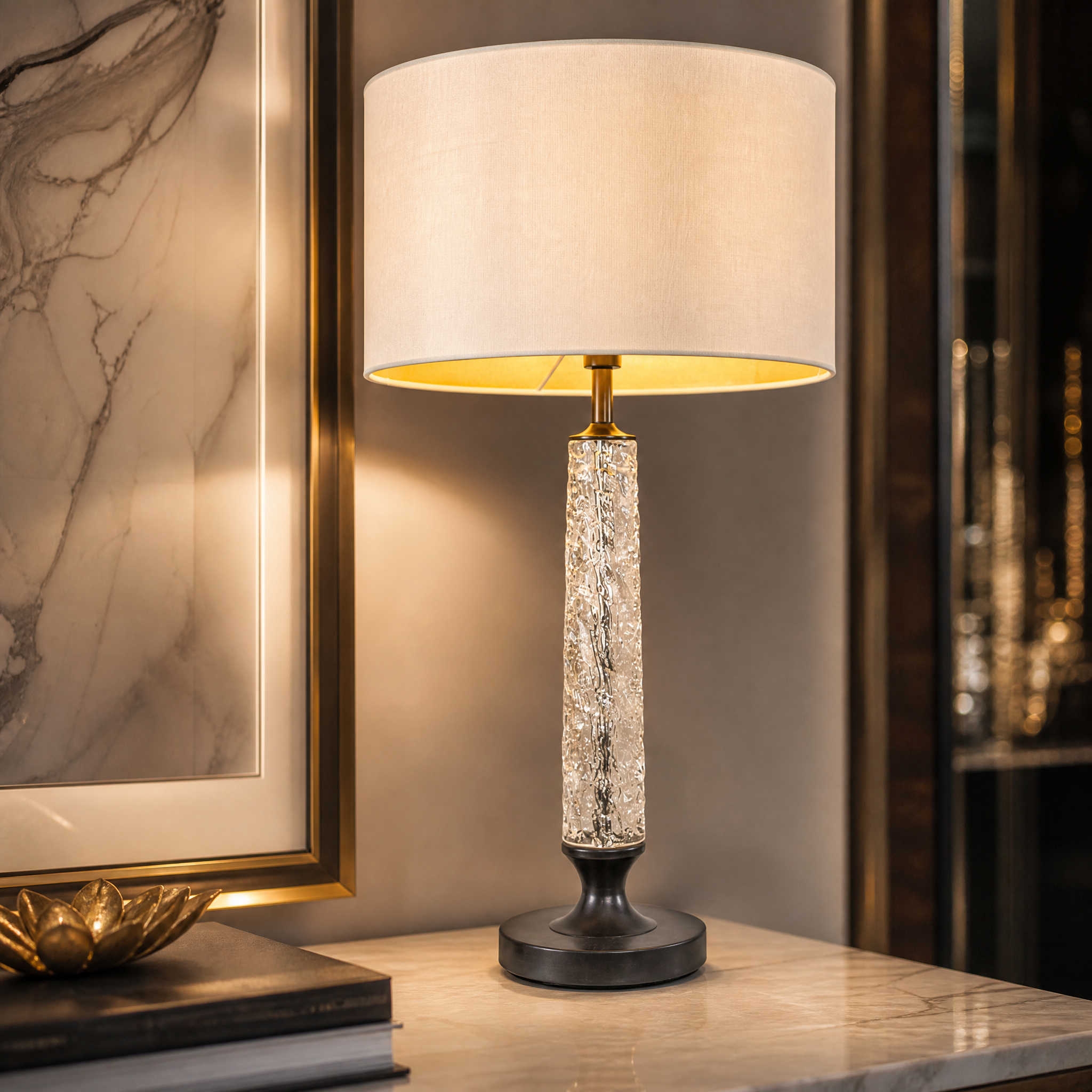 Macro detail shot of the VORELLI Cristaro table lamp highlighting the rich dark bronze base, textured crystal column, and soft cream fabric shade.