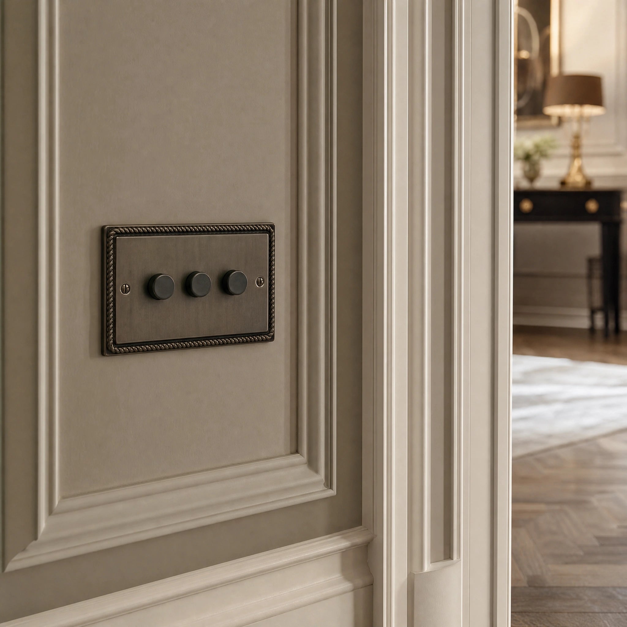Close-up of a luxury antique brass dimmer switch installed within feature wall beside an elegant doorway in a Belgravia-style residence by VORELLI®.
