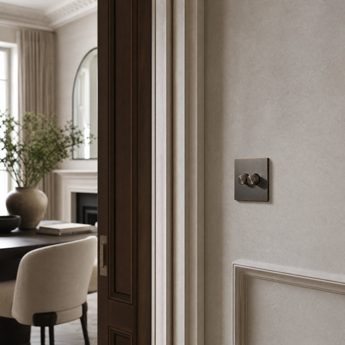 Luxury umber dimmer switch installed within feature wall beside an elegant doorway in a Belgravia-style residence in a UHNW interior by VORELLI®.