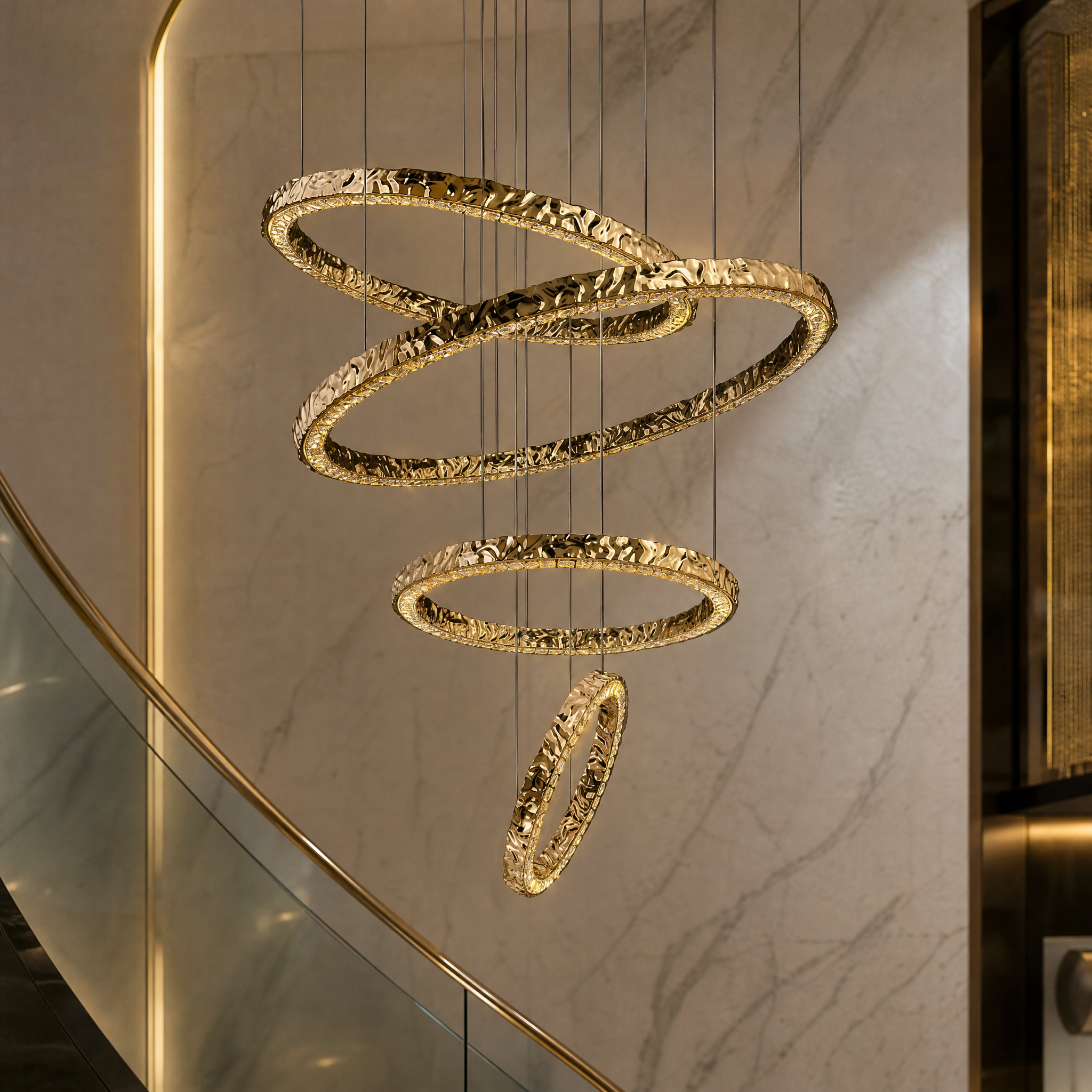Detailed closeup of the VORELLI Ecliptica chandelier showcasing the sophisticated textured gold finish and glowing integrated LED rings.