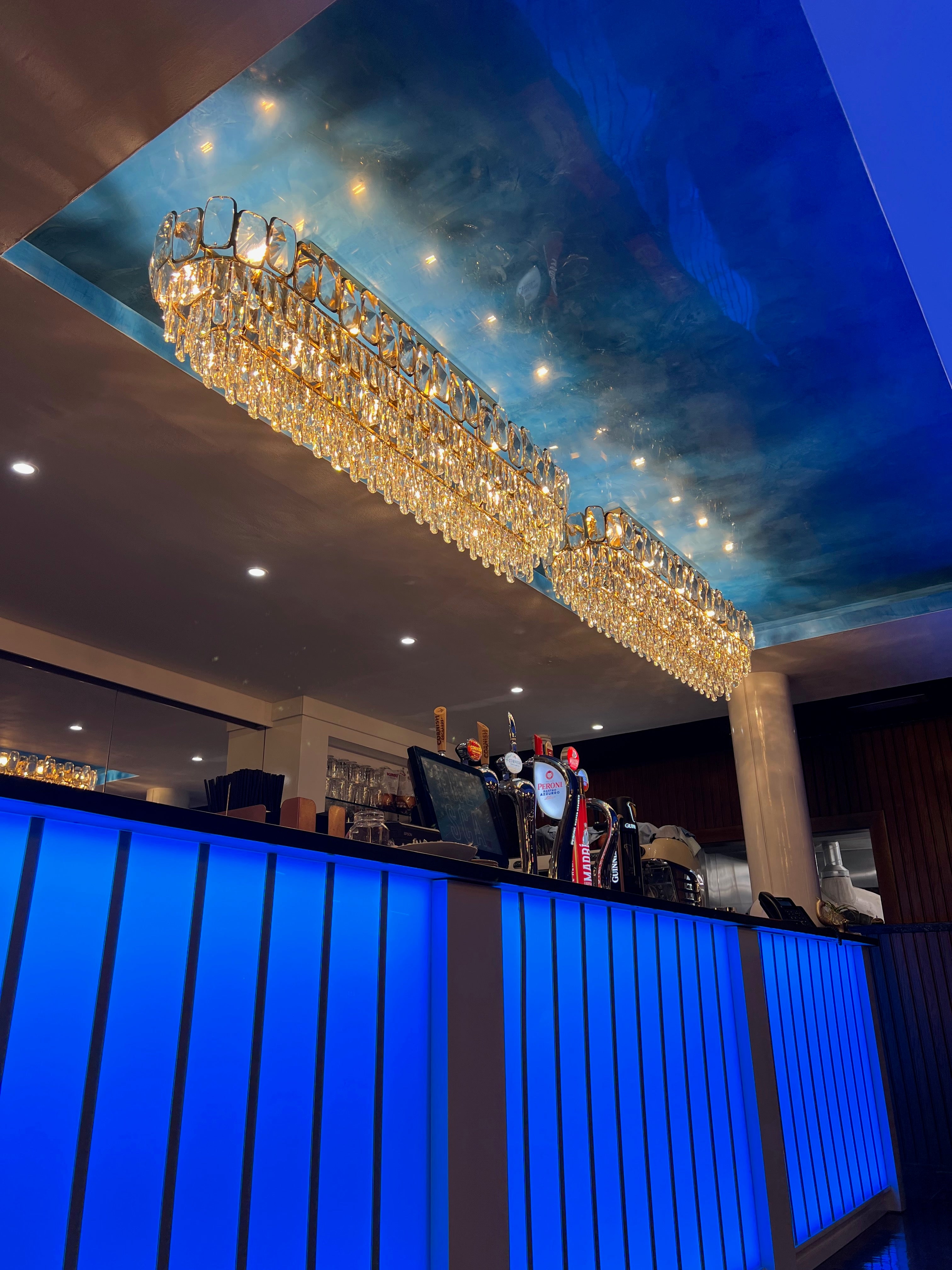 Warm illuminated Edmond rectangular crystal chandelier in contemporary interior