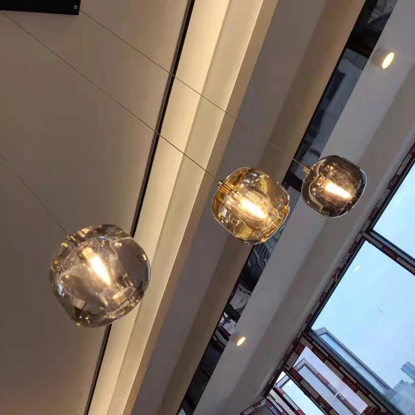 Luxury glass globe pendant detail in amber clear and smoky grey finish by VORELLI®