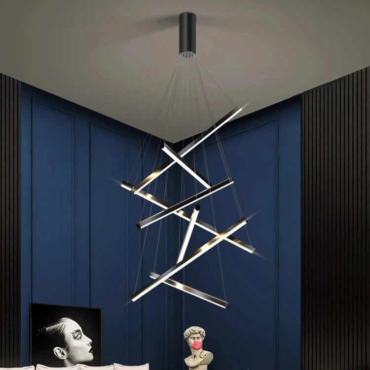 Contemporary pendant staircase chandelier cascading through a double height stairwell space