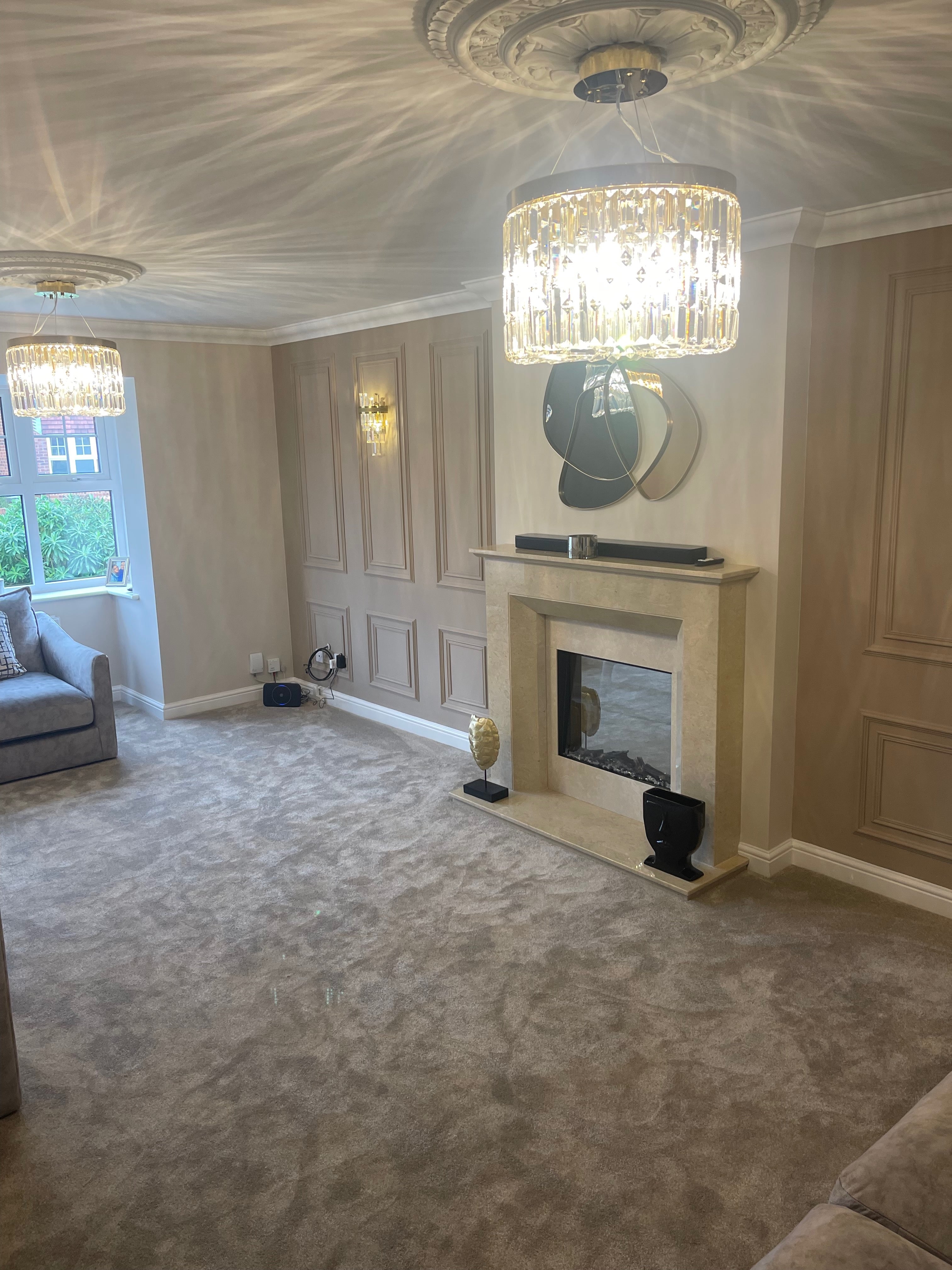 Detailed view of circular crystal chandelier and ceiling reflections in an upscale interior
