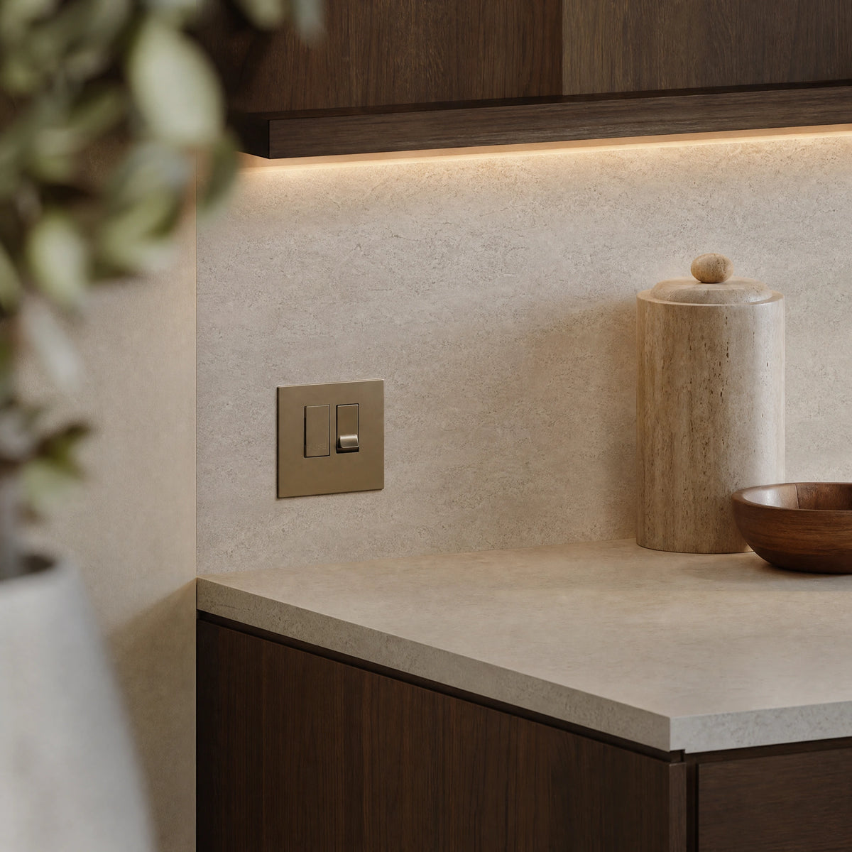 Luxury antique brass fused spur installed within discreet below-cabinet utility or kitchen appliance zone in a high-end residence in a UHNW interior by VORELLI®.