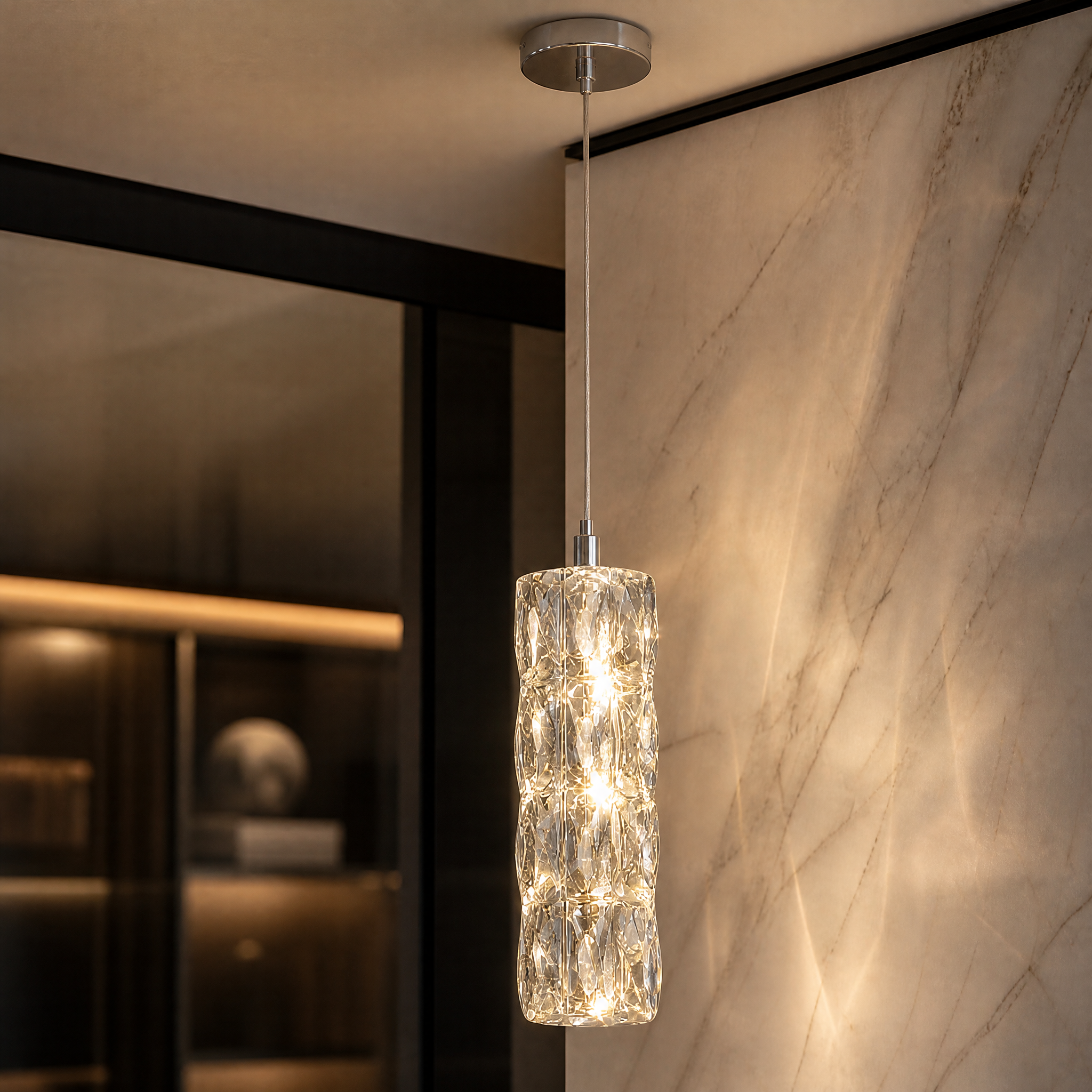 Macro close-up of the VORELLI Gaia pendant light showcasing the intricate diamond-cut rectangle crystals encircling the refined cylinder fixture.