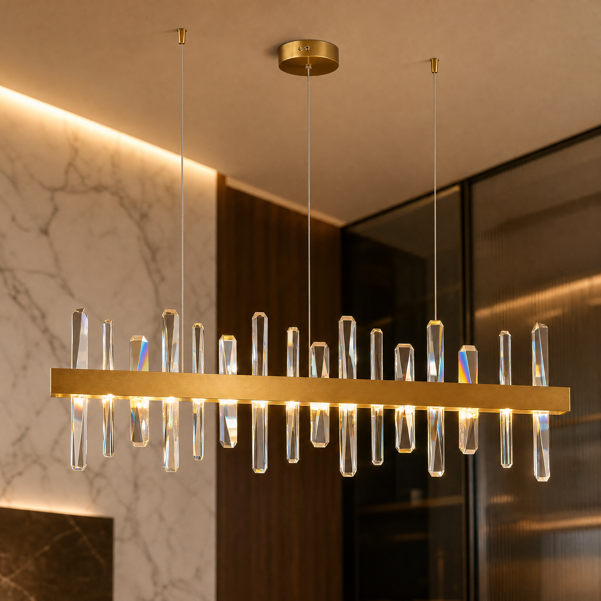 A detailed closeup of the VORELLI Grantchester rectangular chandelier showing varied-size vertical thick crystals set in a sleek stainless steel frame.