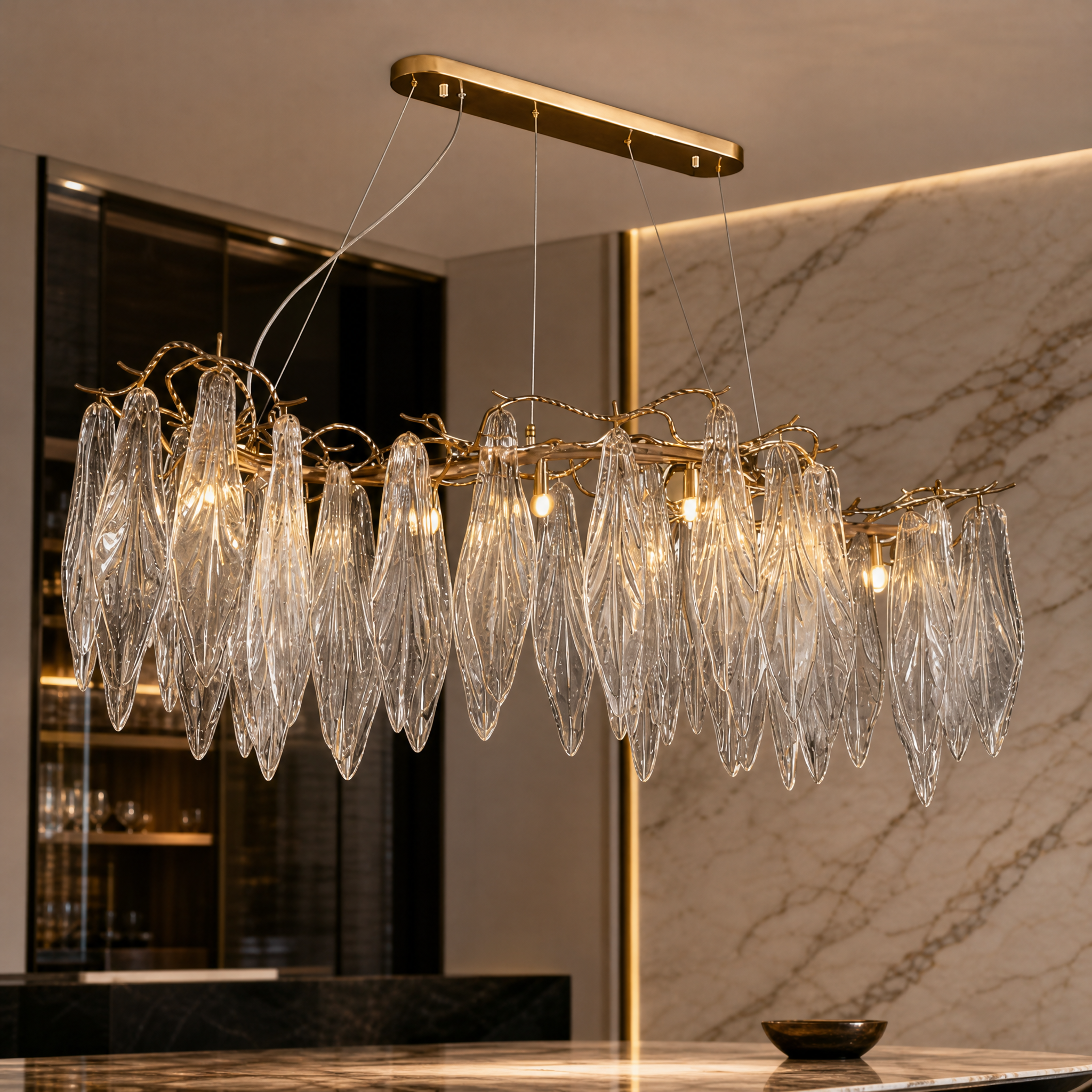 A detailed closeup of the VORELLI Larvotto chandelier showcasing the intricate sculptural branches and hand-shaped leaf glass elements.