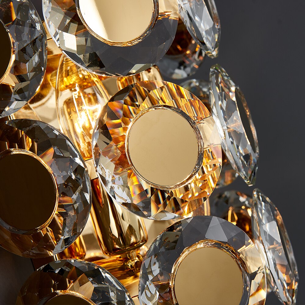 Close-up of diamond cut crystal discs and gold stainless steel structure on the VORELLI Manzoni wall light