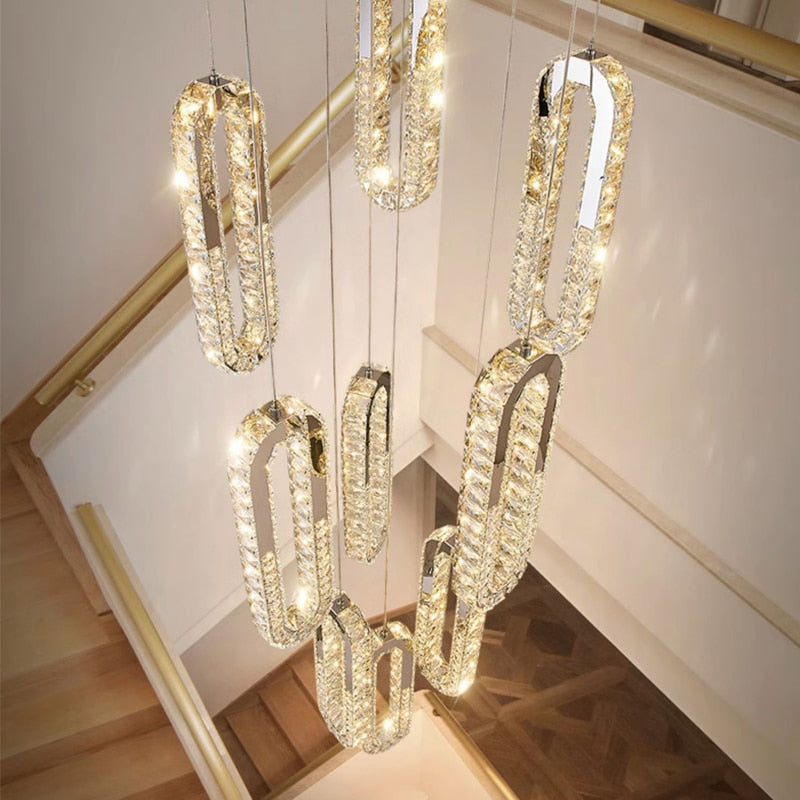 Close-up of VORELLI Manzoni crystal edge detailing on a modern pendant staircase chandelier