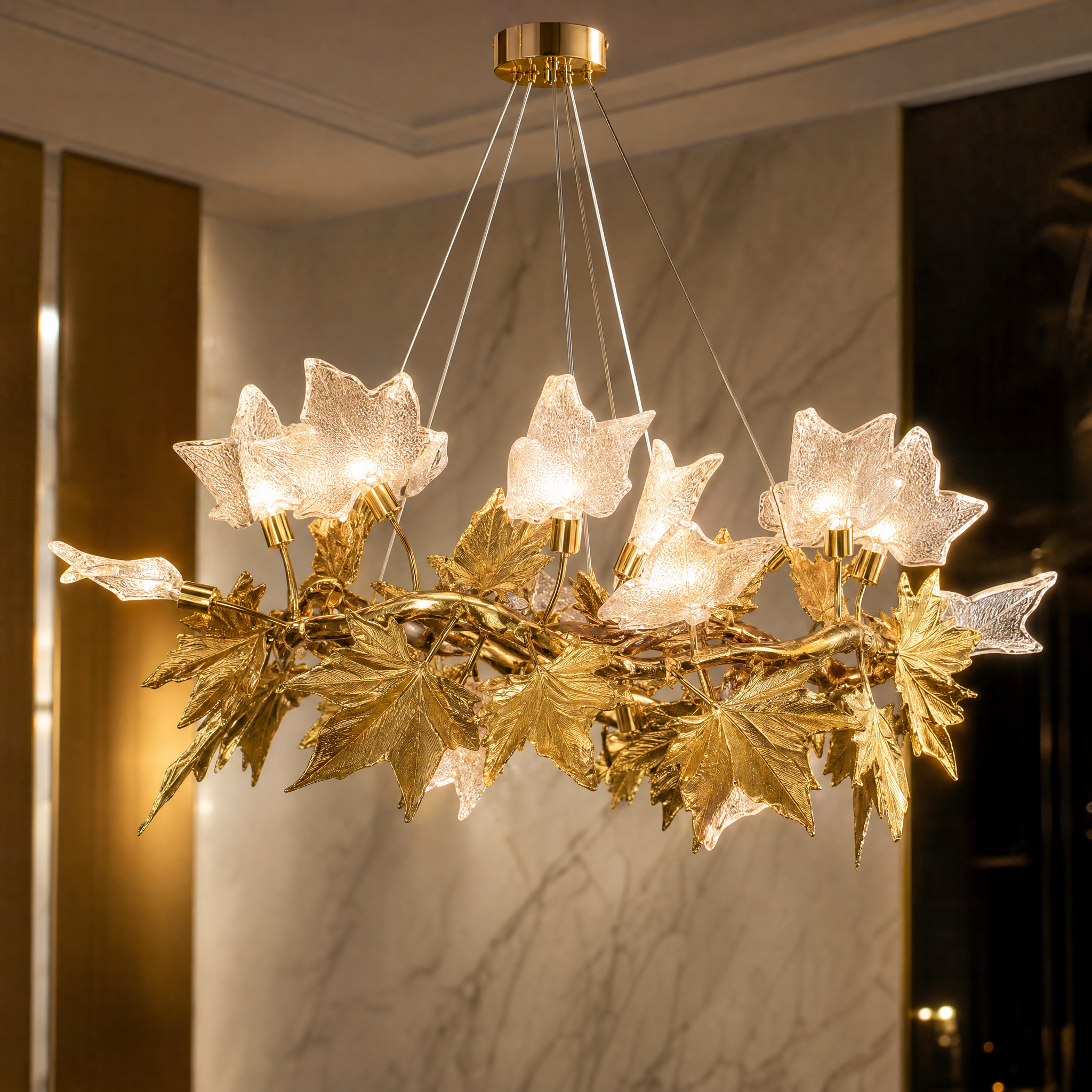 A detailed closeup of the VORELLI Maple Grove Circular Chandelier II highlighting the intricate sculpted leaf detailing and high-end craftsmanship.
