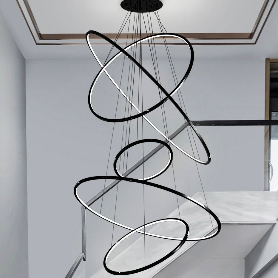 Modern black LED ring staircase chandelier from VORELLI forming a sculptural spiral lighting feature