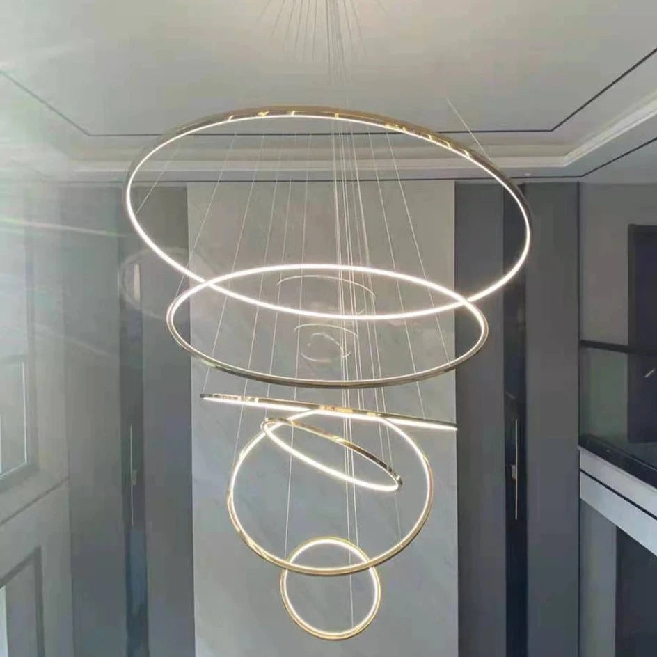 VORELLI Marcello multi-ring chandelier suspended in a double-height interior creating a dramatic modern focal point