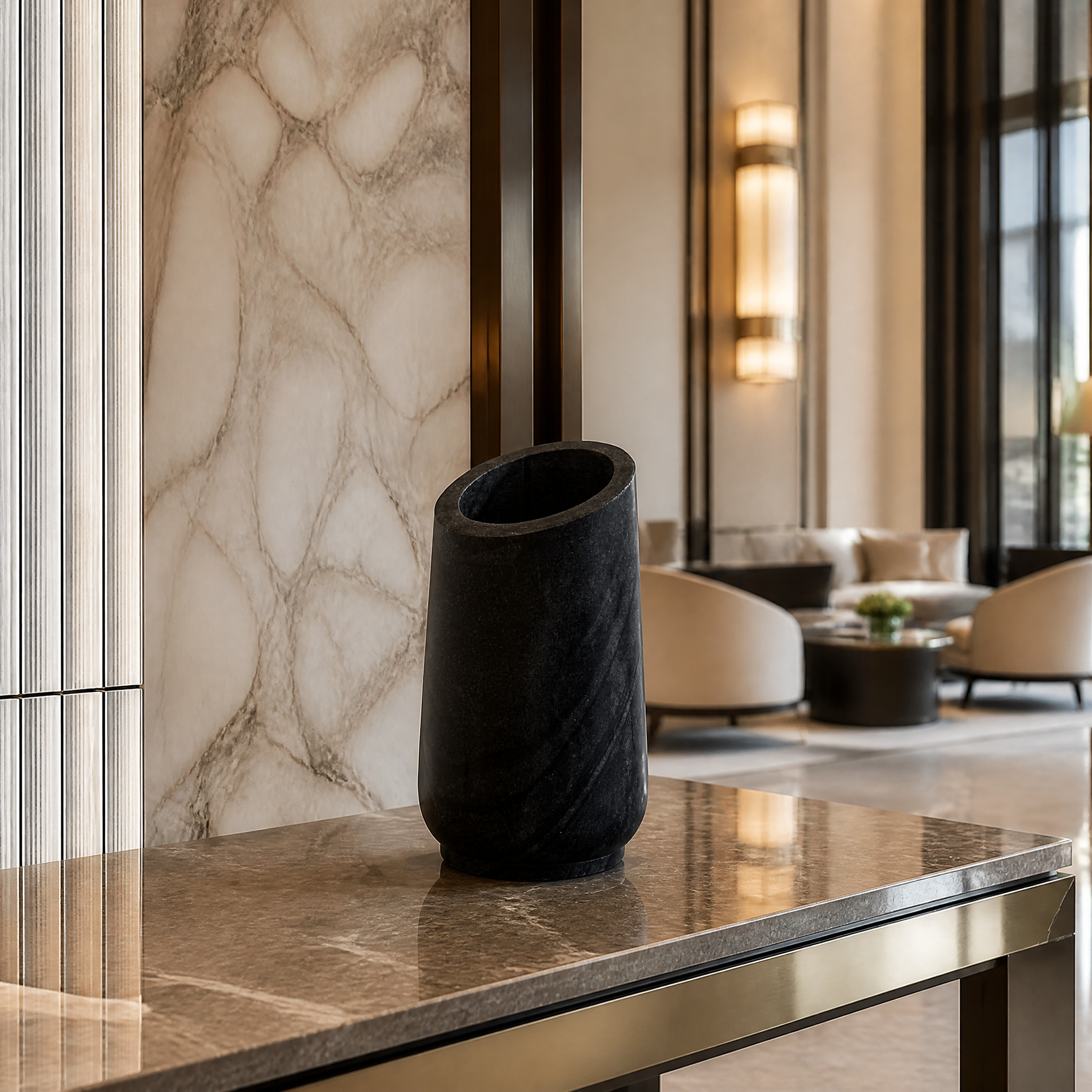 Premium black marble decorative vase with a polished finish and sharp angled rim styling a modern hospitality lounge or hotel reception desk.