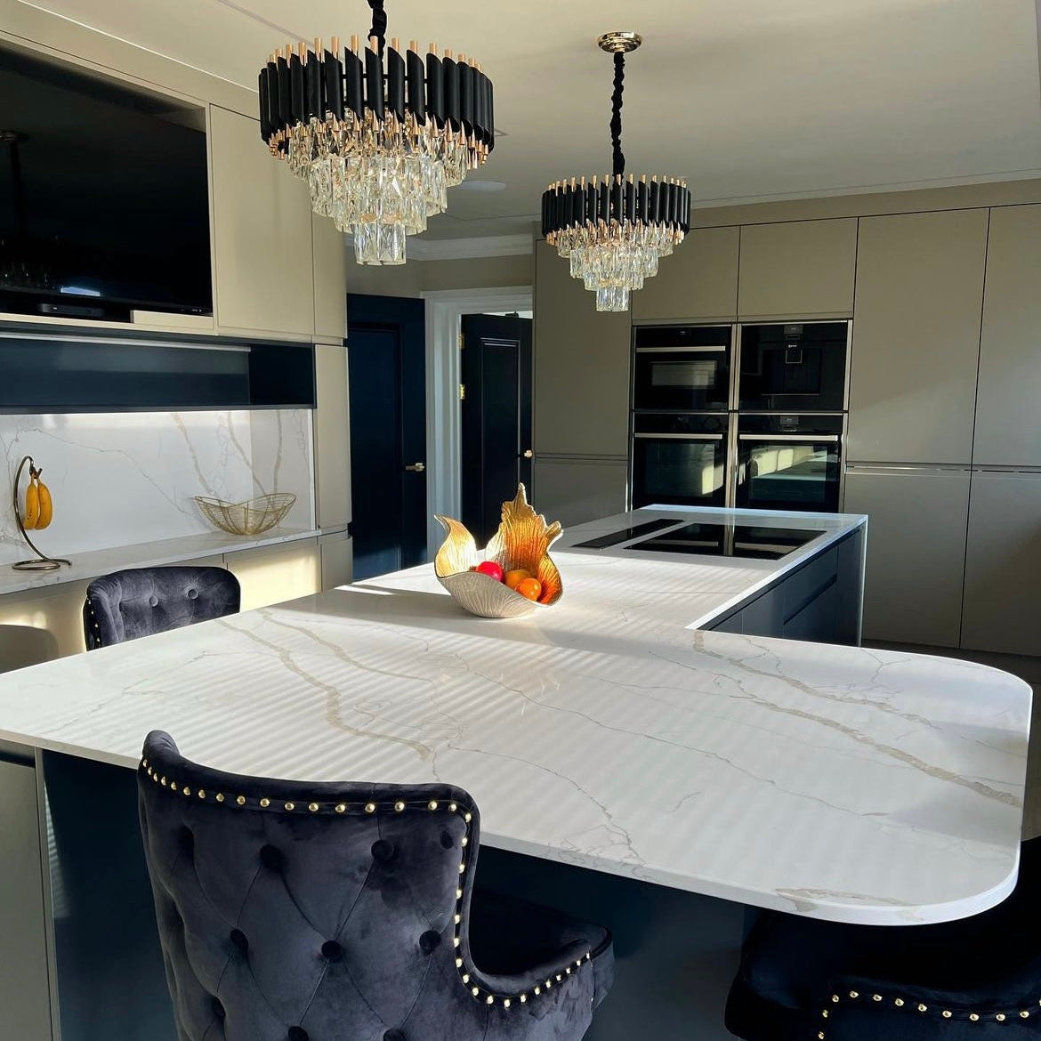 VORELLI Milltimber Pendant Light installed above a modern kitchen island featuring layered crystal drops and cylinder tubing