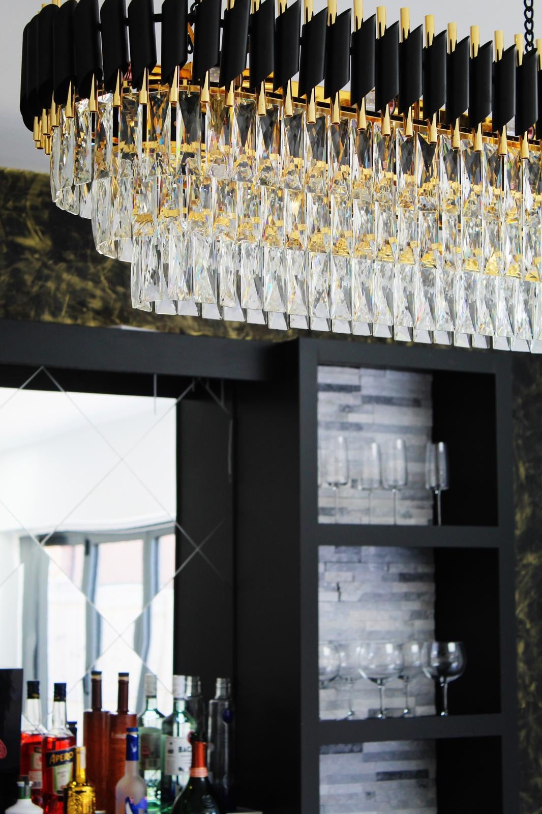 Close up of VORELLI® Milltimber rectangular chandelier showing diamond cut crystal prisms and precision cylinder tubing