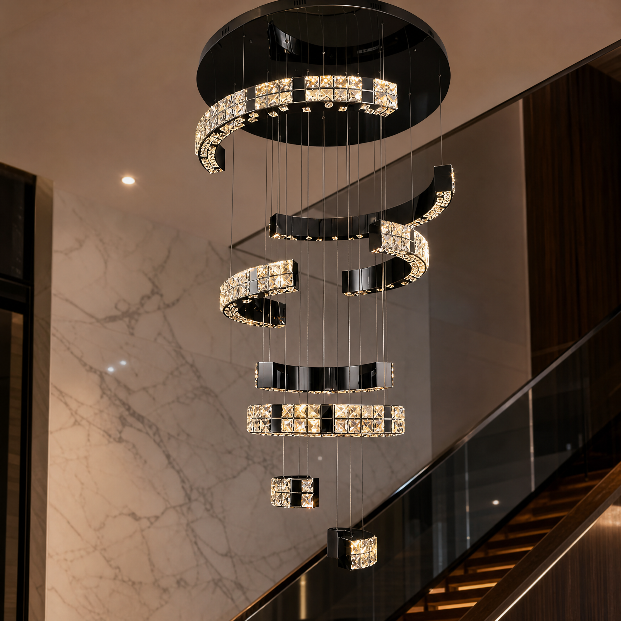A detailed macro closeup of the VORELLI Minato staircase chandelier showing the intricate craftsmanship and brilliant light refraction of its diamond-cut crystals.