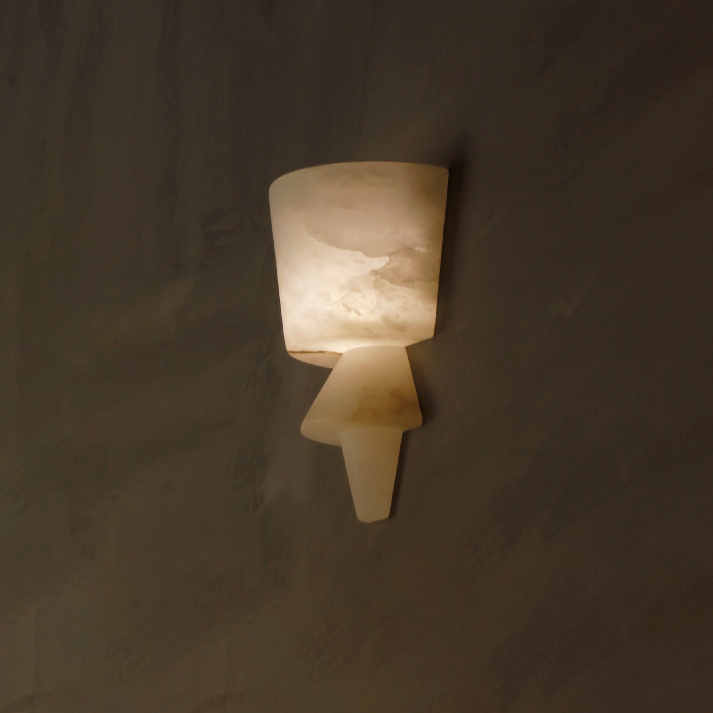 VORELLI® Napoli marble wall sconce installed in refined interior casting soft diffused glow