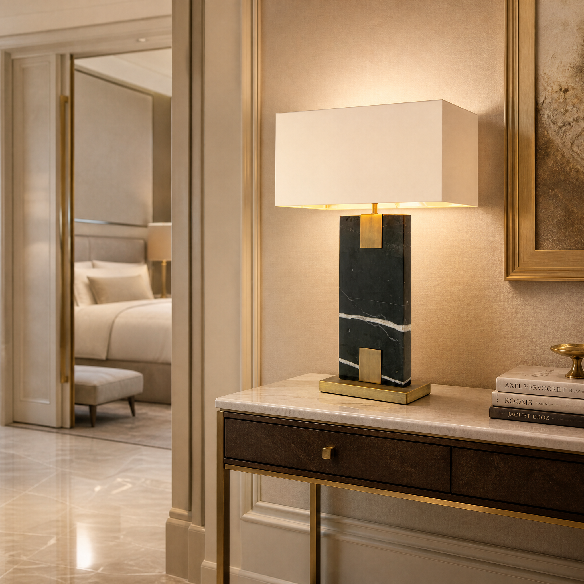 The Navaro contemporary black marble table lamp casting a warm ambient glow on a console table in a luxury hospitality or hotel lounge setting.