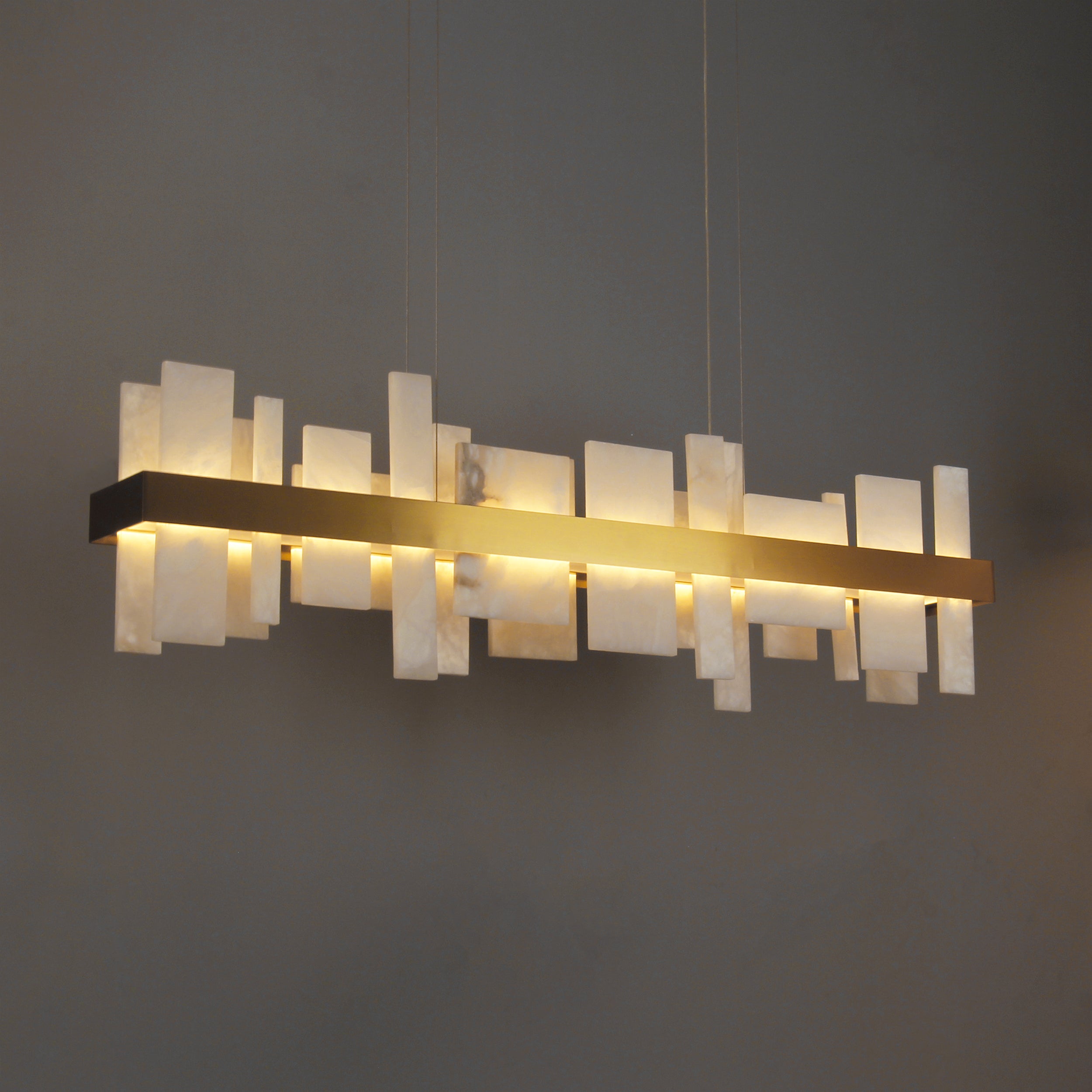 VORELLI® Niva modern marble rectangular chandelier installed in contemporary interior with structured stone panel design