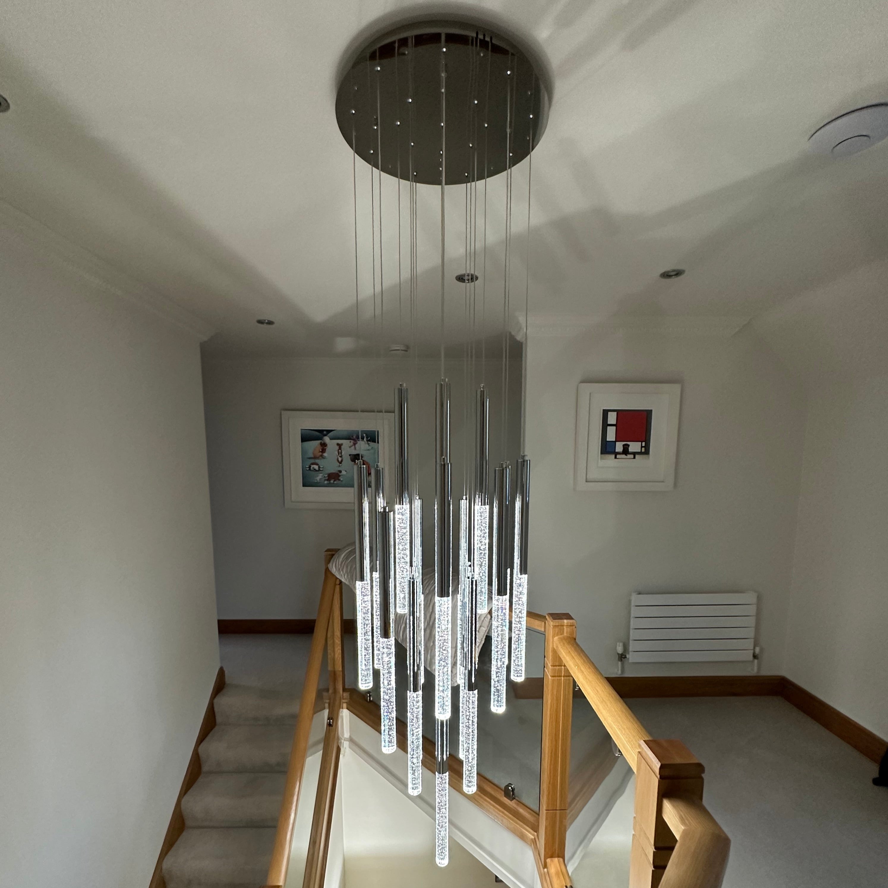 Close up of bubble effect crystal pendants on VORELLI® Nyon staircase chandelier
