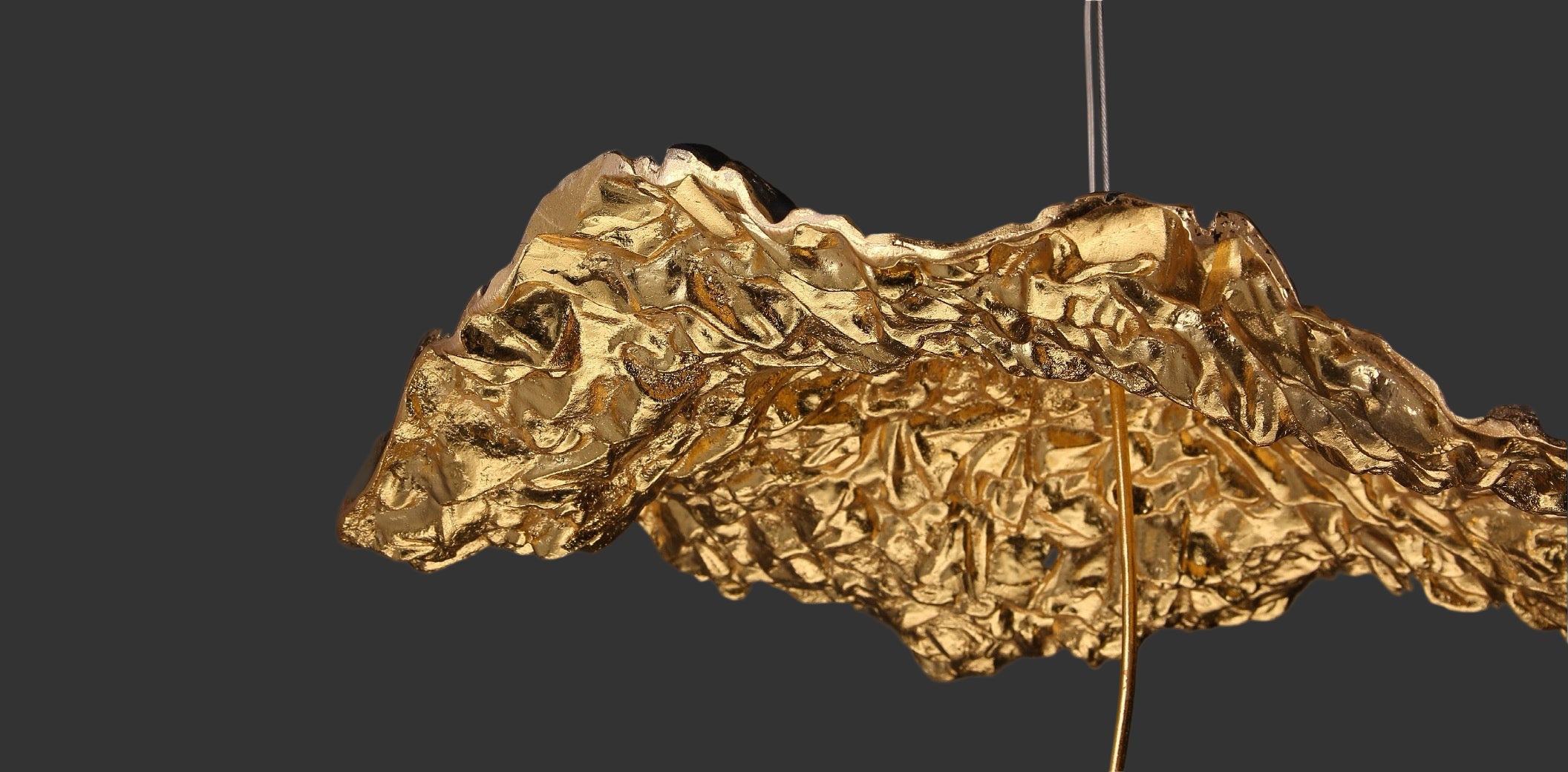 Close-up of Obscura pendant light with black and gold textured underside