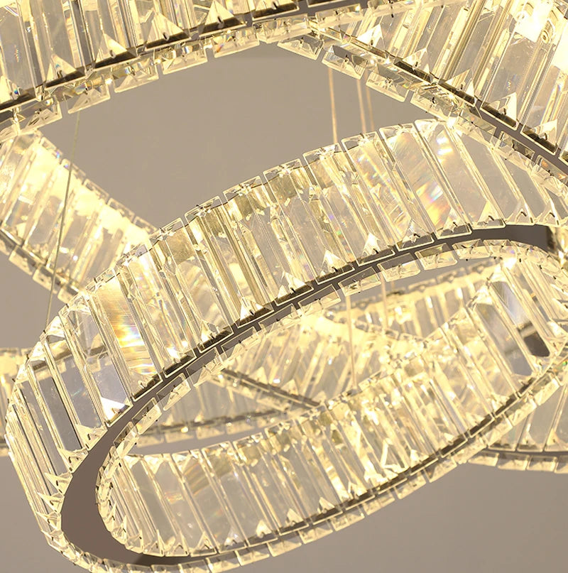 Modern VORELLI® Oia ring staircase chandelier with illuminated crystal detailing enhancing a grand interior space