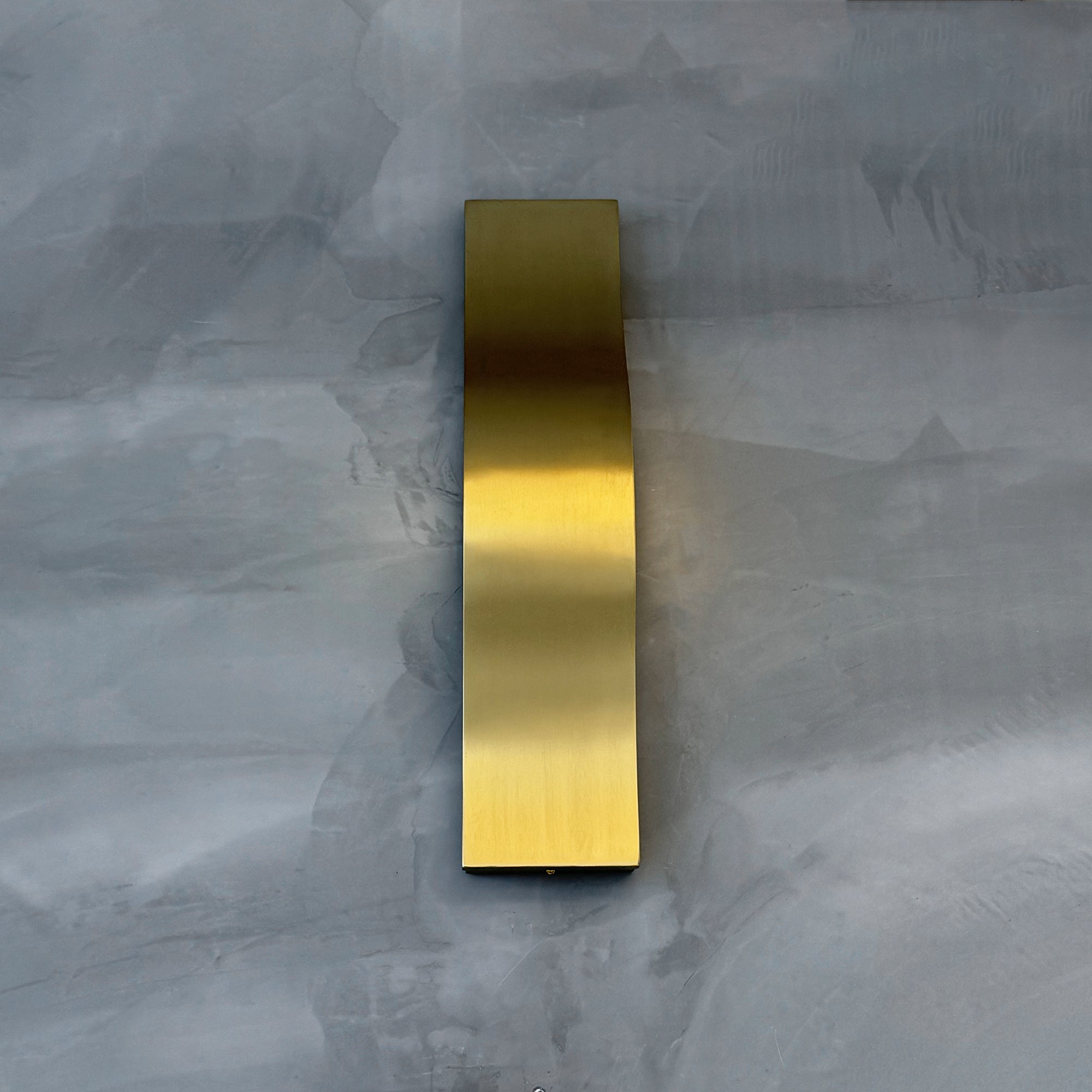 Close up of VORELLI® Ondina wall light highlighting fluid curved form and concealed illumination