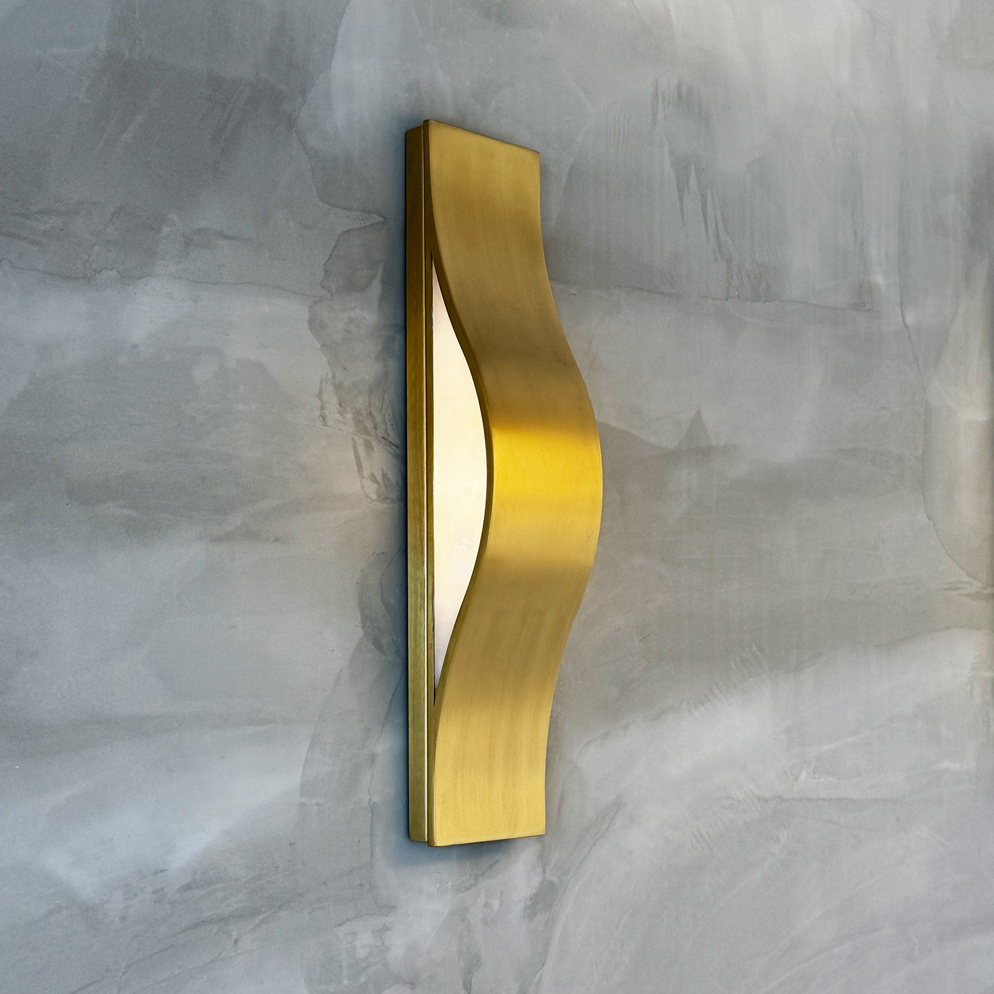 VORELLI® Ondina modern wave wall sconce mounted on textured wall showcasing curved sculptural silhouette