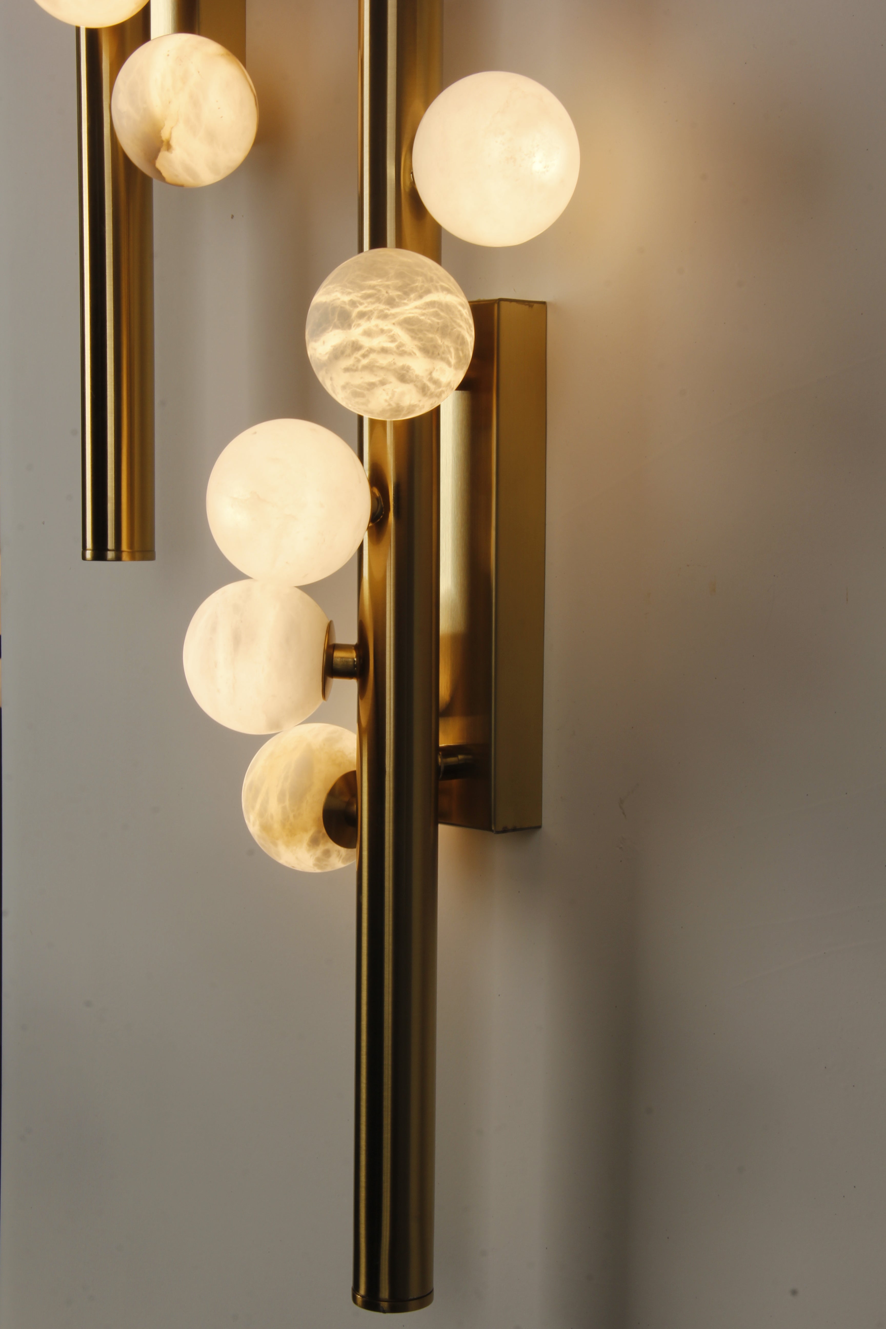 Pair of VORELLI® Orbit marble wall lights installed symmetrically in upscale interior space