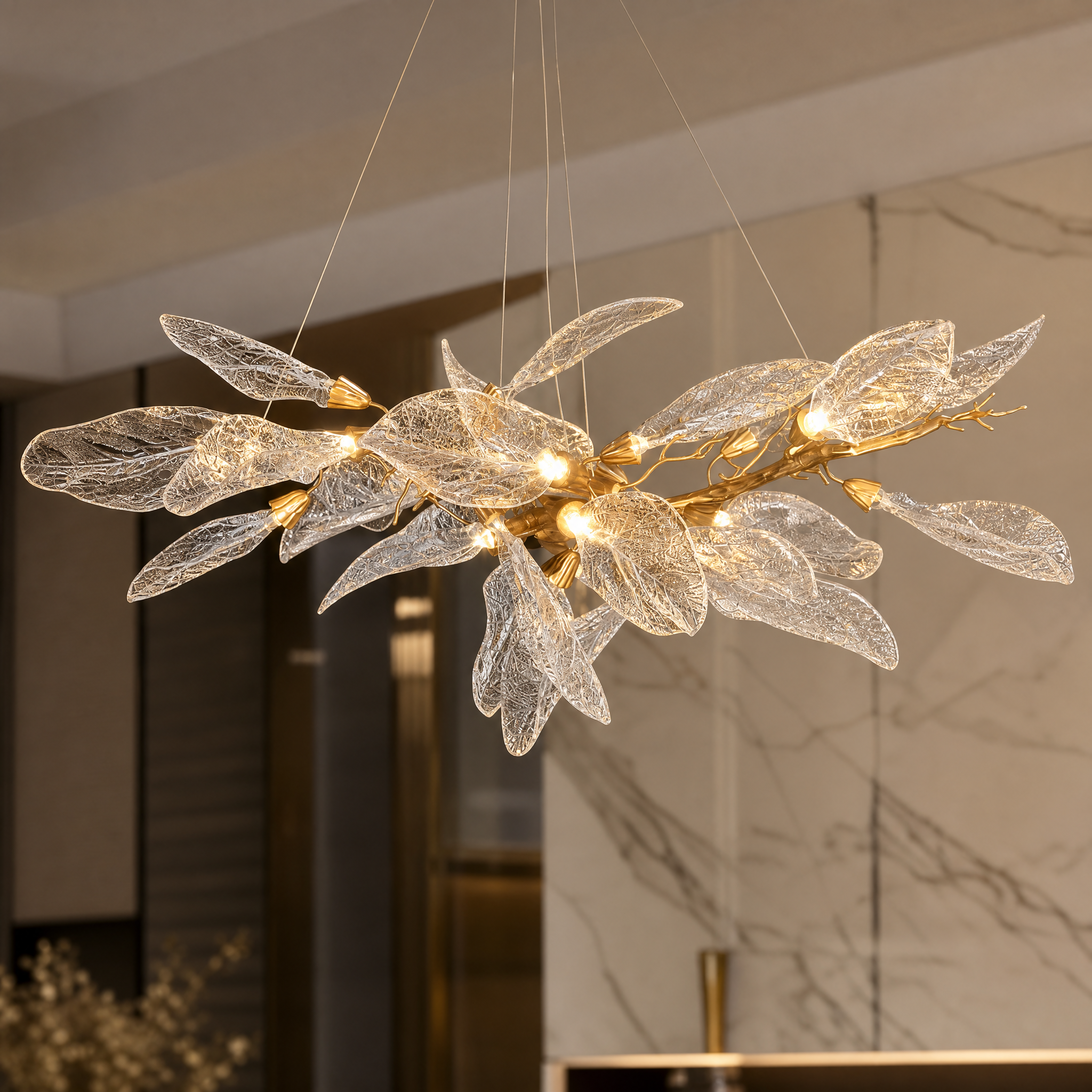 Close-up detail of the VORELLI Ottobre chandelier showcasing the intricate texture and craftsmanship of the elongated glass leaf forms.