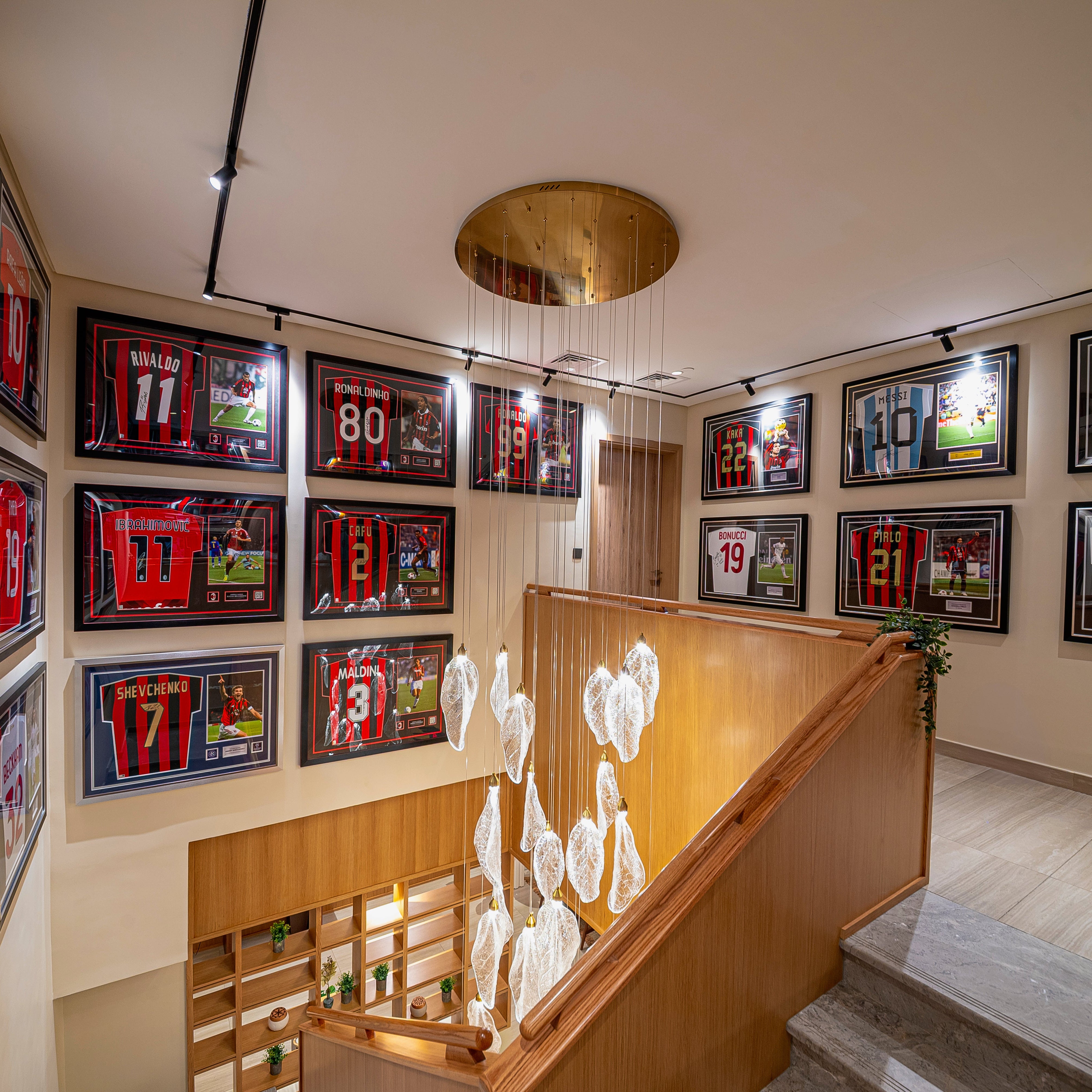 Close view of VORELLI® Ottobre crystal pendant staircase lighting suspended from a circular ceiling plate in a contemporary luxury space