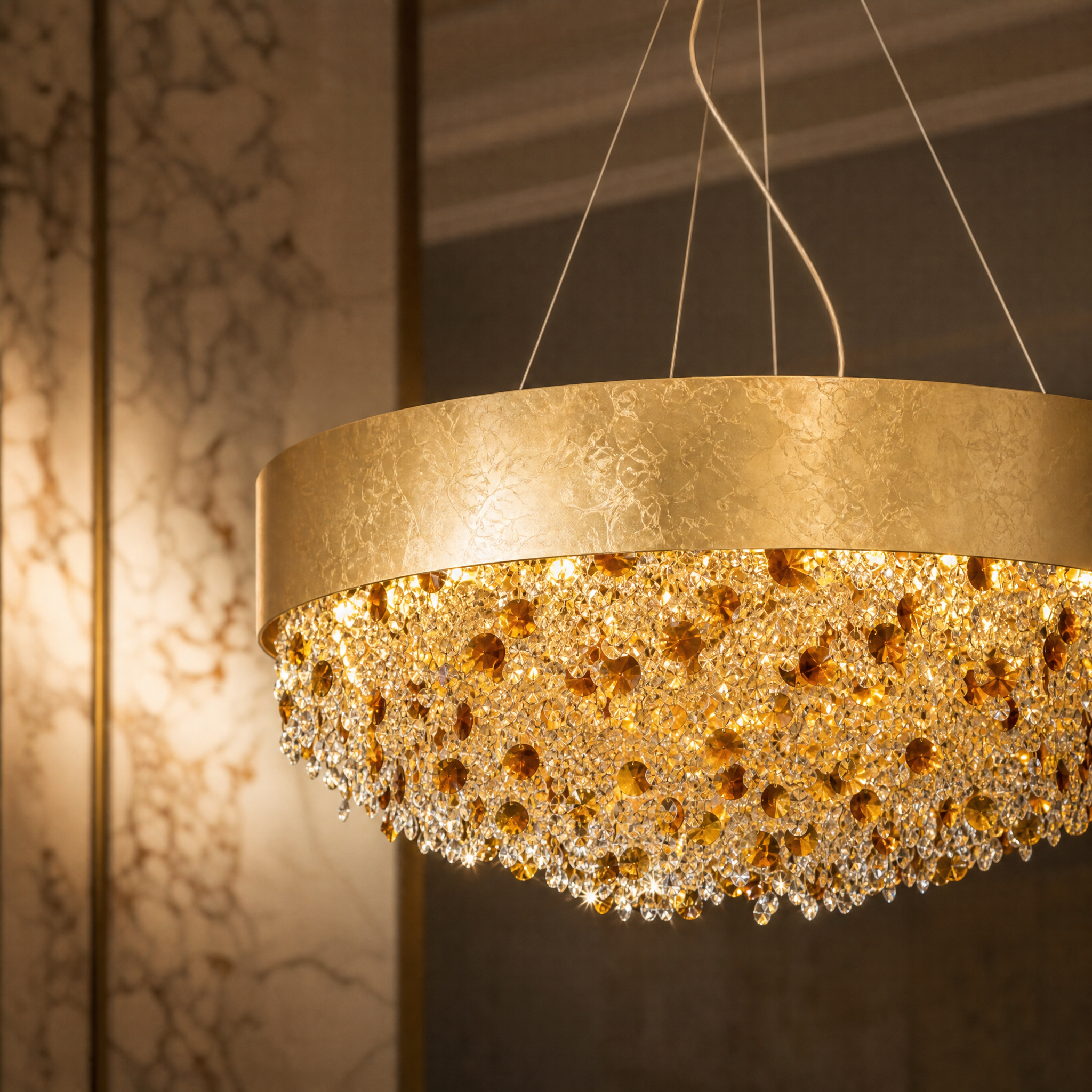 A detailed close-up of the VORELLI Owensboro chandelier, highlighting the diamond-cut octagon crystal chains against the textured gold foil circular frame.