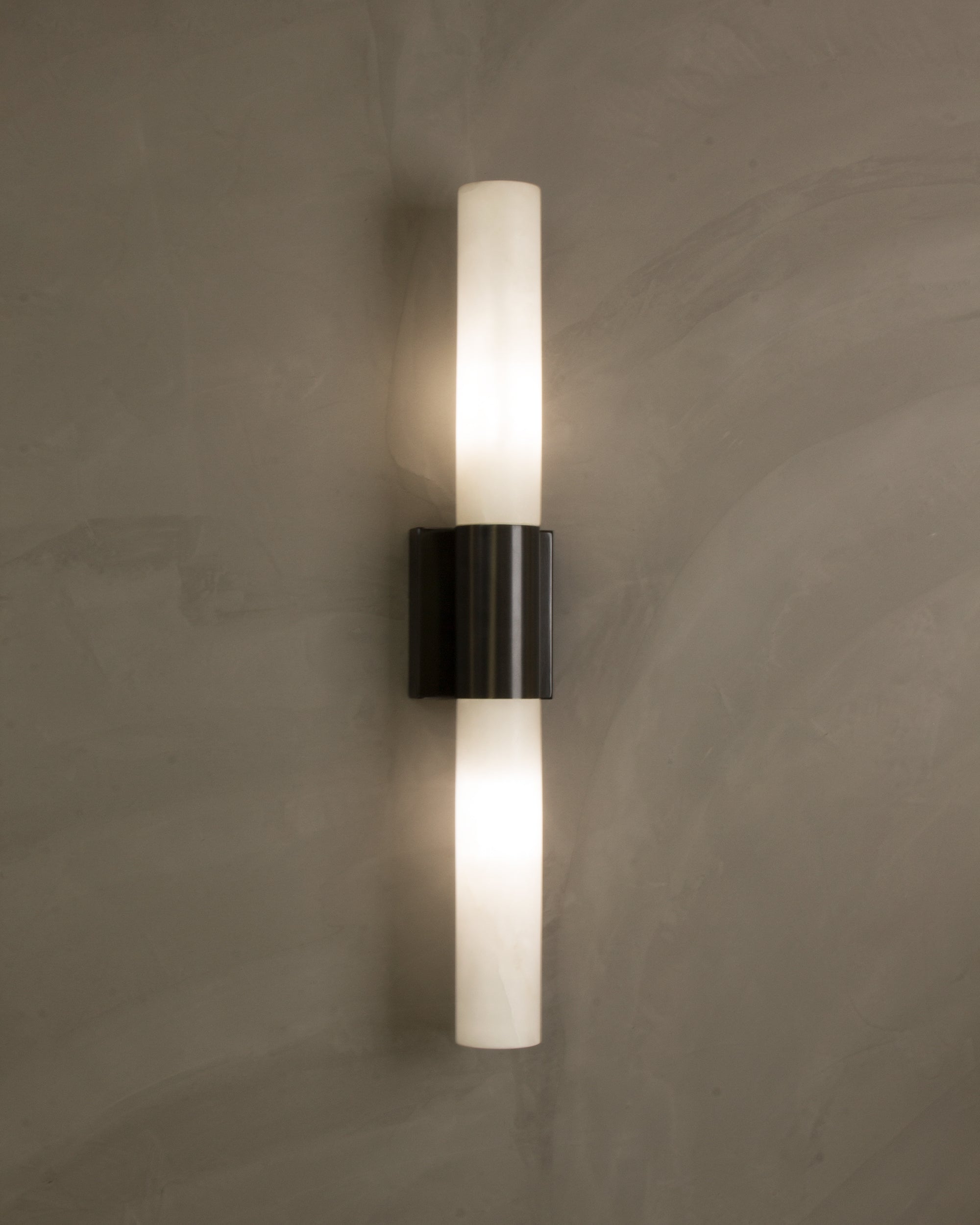 VORELLI® Palermo modern marble wall sconce installed in contemporary interior creating balanced vertical illumination