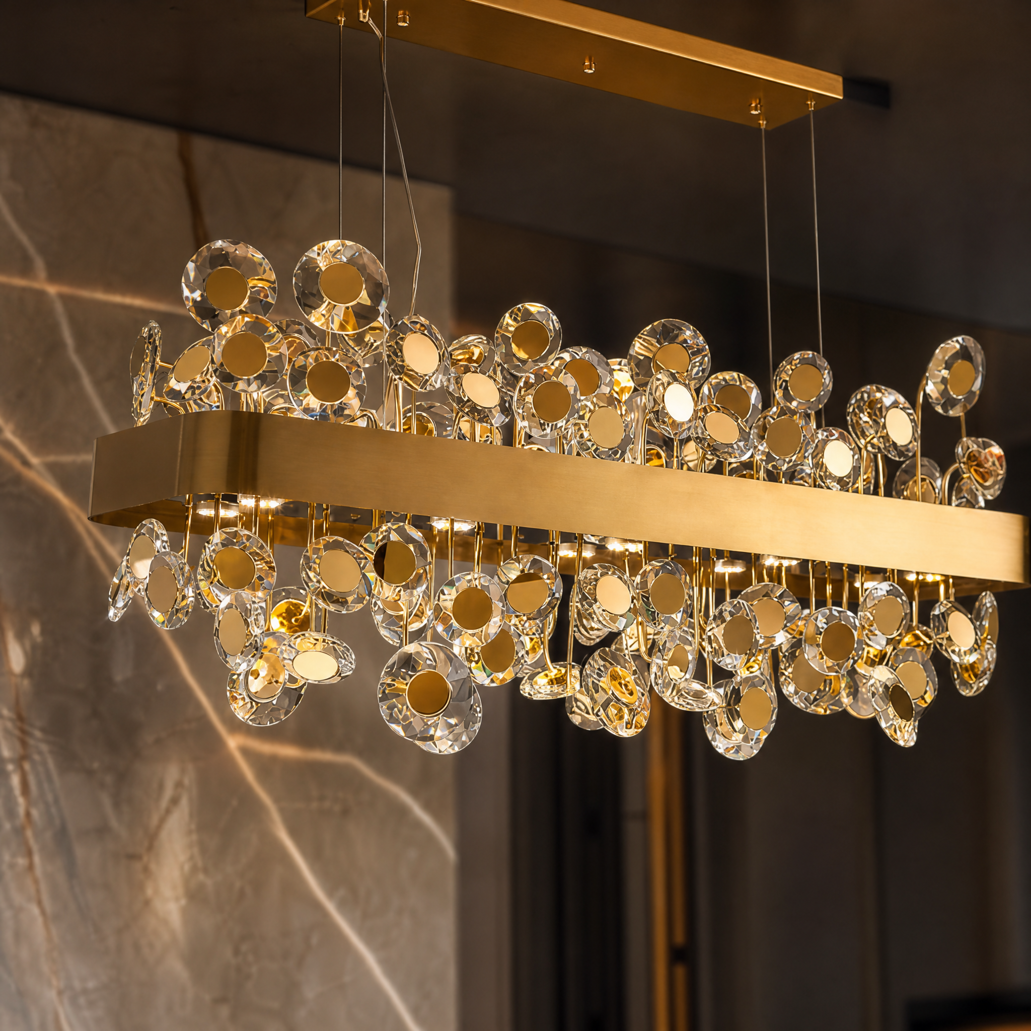 Close-up detail of the VORELLI Patara rectangular chandelier showcasing its precision diamond-cut crystal discs and stainless steel frame.