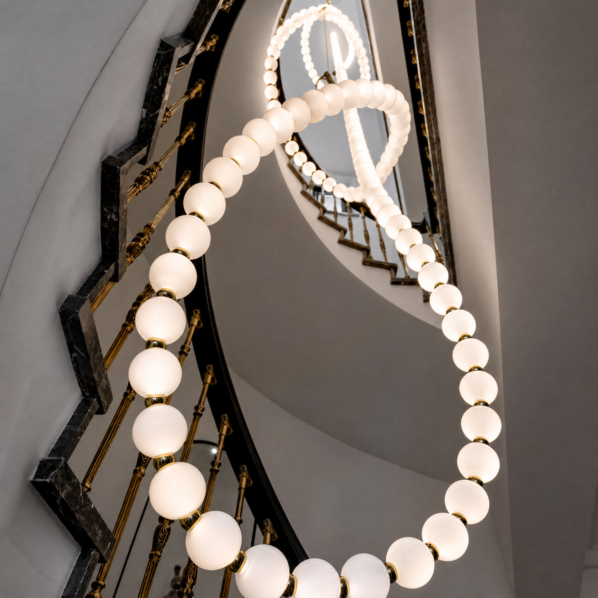Detailed closeup of a VORELLI Pearl Globe illuminated glass sphere, showing the refined contemporary craftsmanship and soft glow.