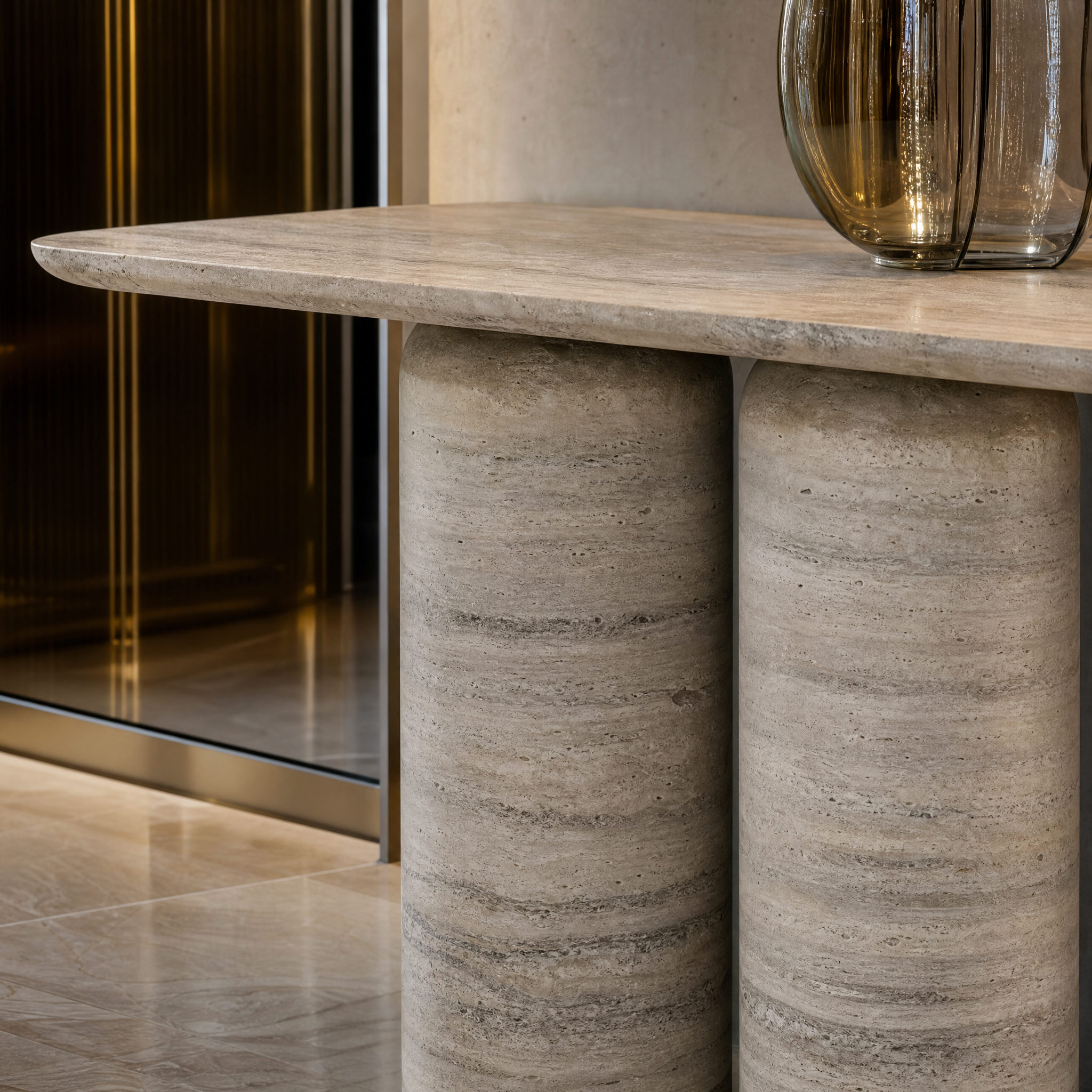 Macro view of the solid honed silver travertine texture and double-pedestal craftsmanship of the VORELLI Posillano console table.