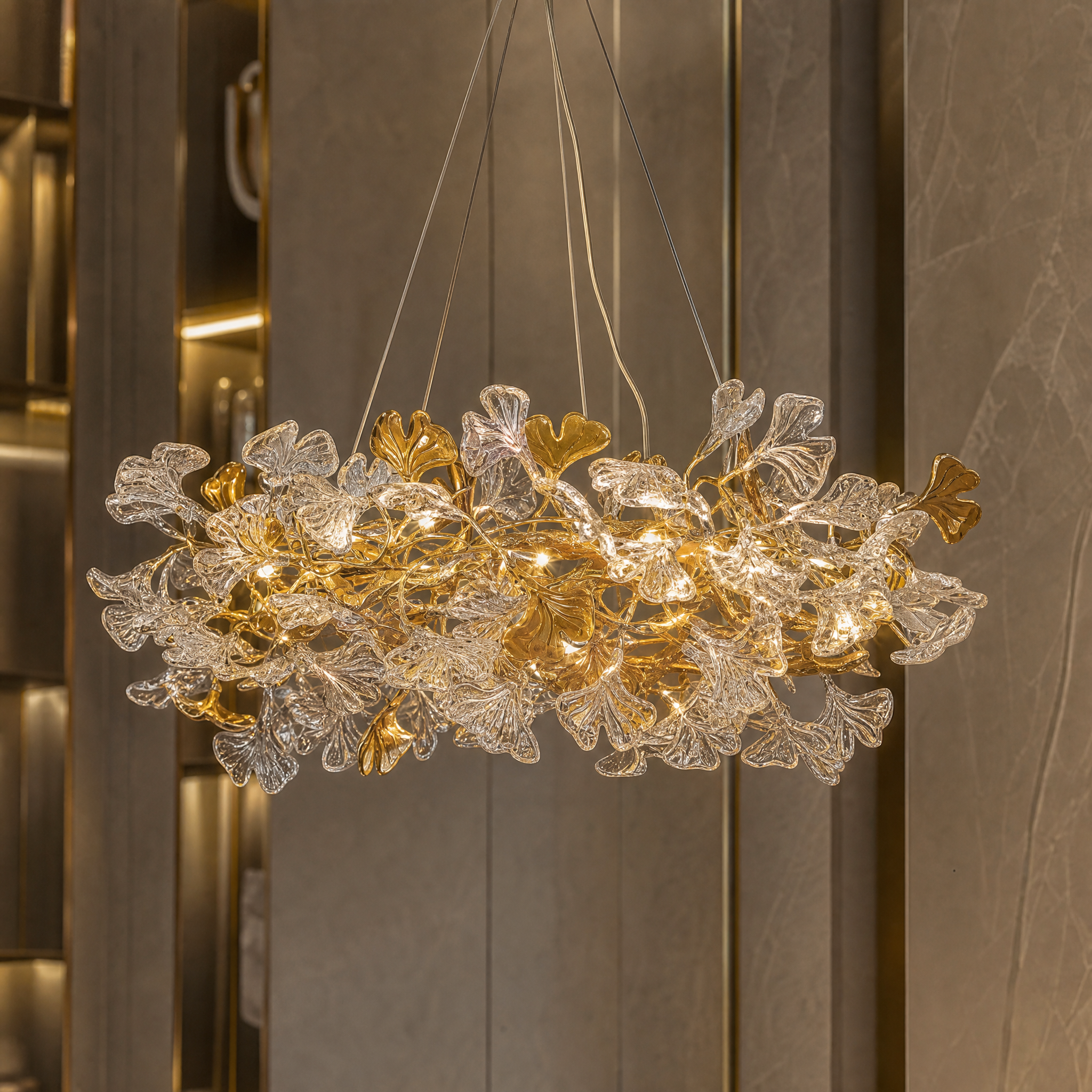 Detailed closeup of the layered glass leaf forms and refined central structure of the VORELLI Prano circular chandelier