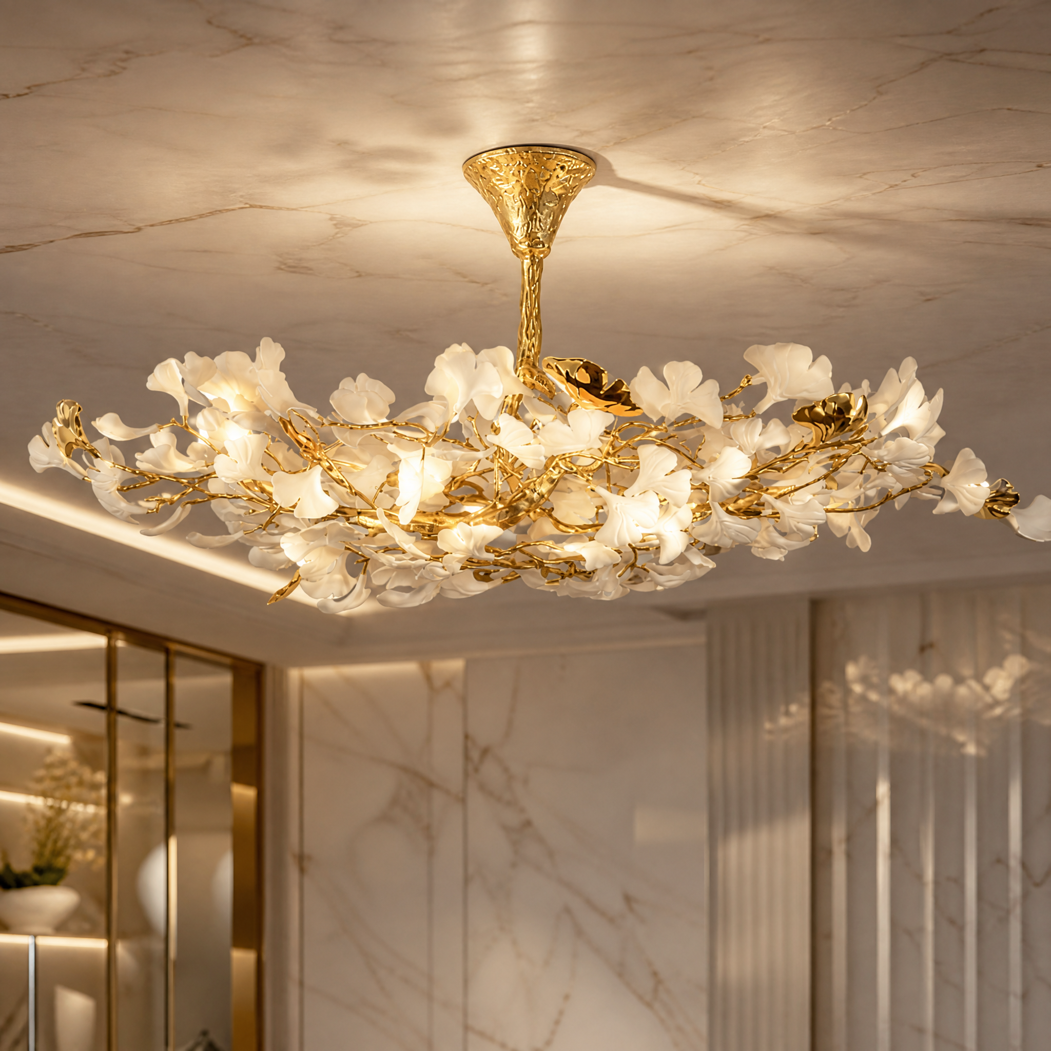 A detailed close-up shot of the VORELLI Prano ceiling light, showcasing the intricate flowing floral glass forms and organic branch structure that add visual depth.