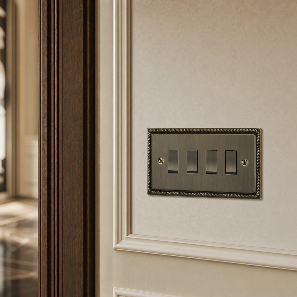Close-up of a luxury antique brass rocker switch installed within feature wall beside an elegant doorway with refined timber panelling by VORELLI®.