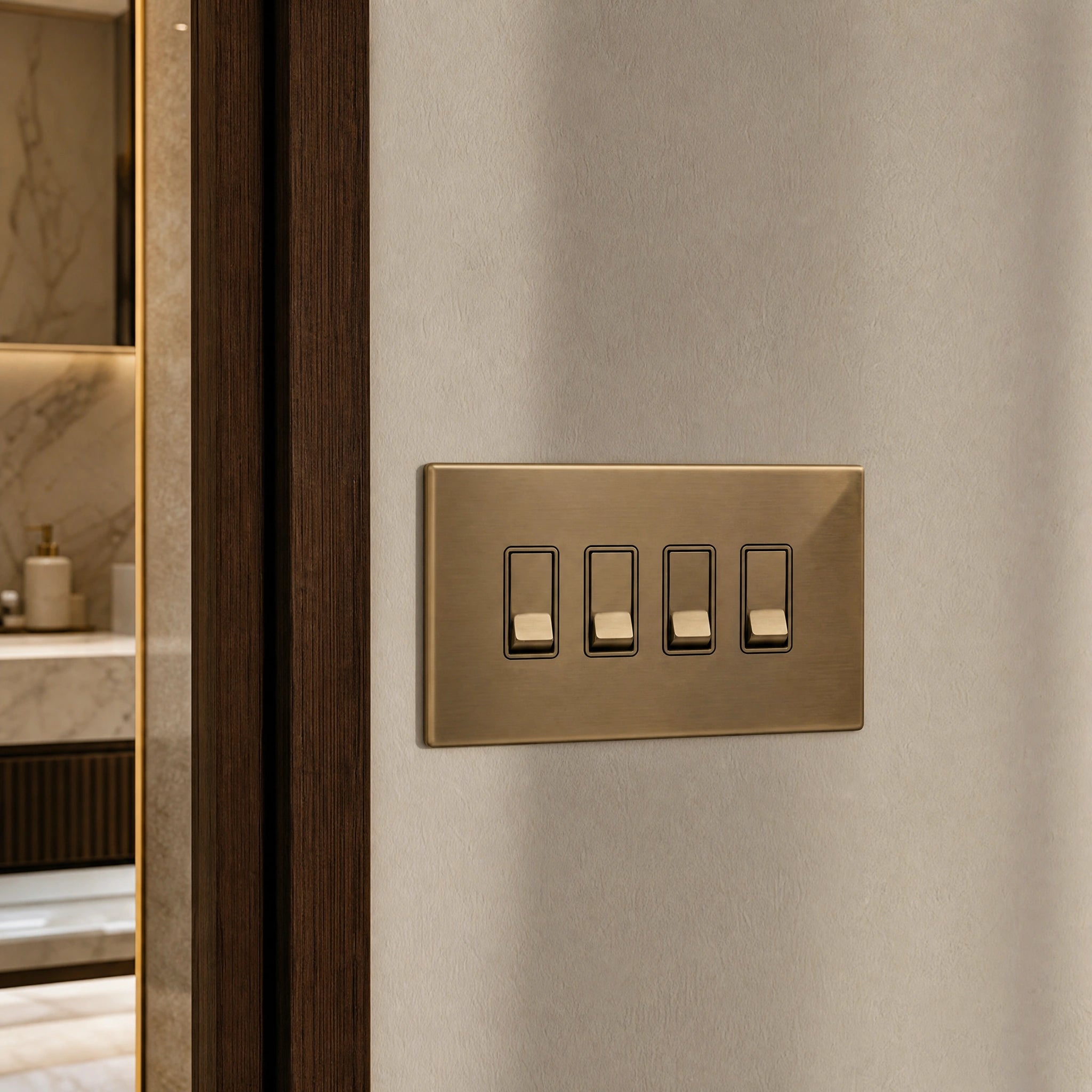 Close-up of a luxury antique brass rocker switch installed within feature wall beside an elegant doorway with refined timber panelling by VORELLI®.