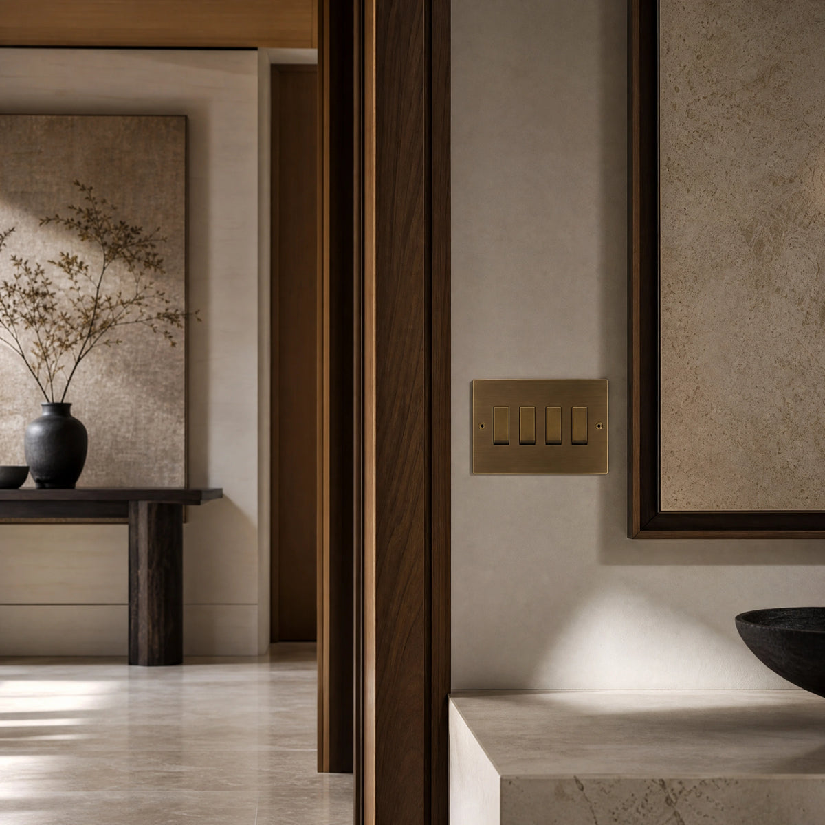 Luxury antique brass rocker switch installed within feature wall beside an elegant doorway with refined timber panelling in a UHNW interior by VORELLI®.