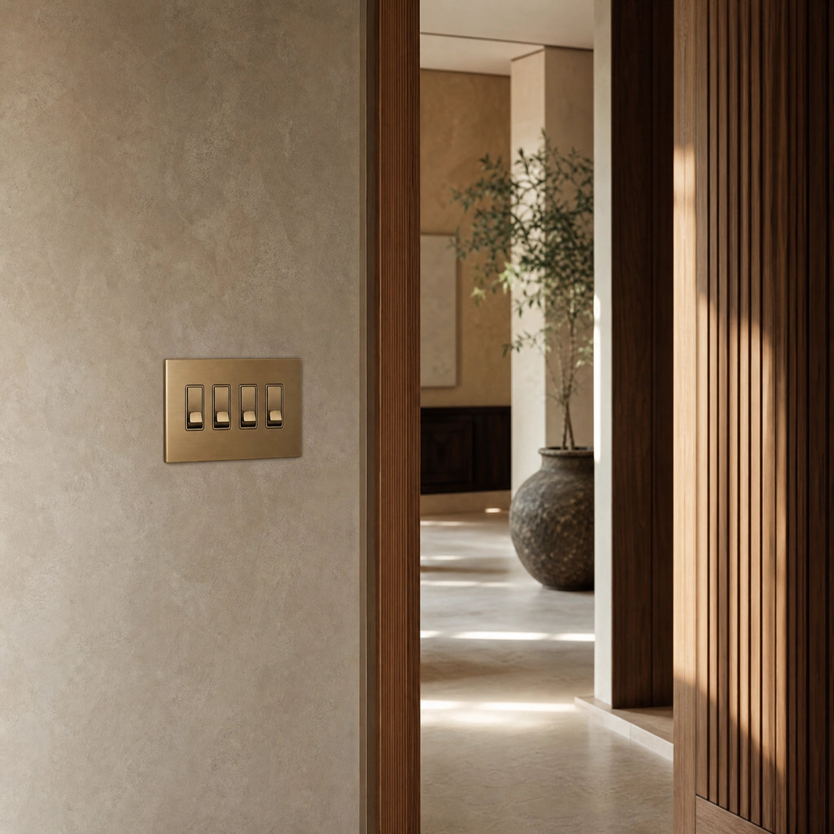 Luxury antique brass rocker switch installed within feature wall beside an elegant doorway with refined timber panelling in a UHNW interior by VORELLI®.