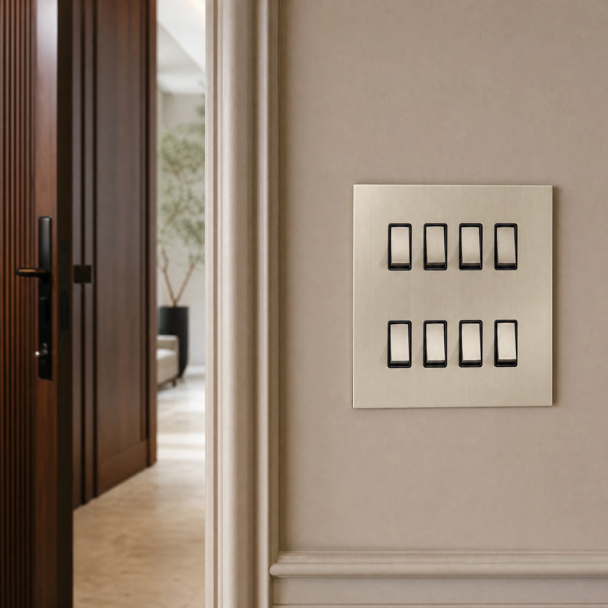 Close-up of a luxury sienna rocker switch installed within feature wall beside an elegant doorway with refined timber panelling by VORELLI®.