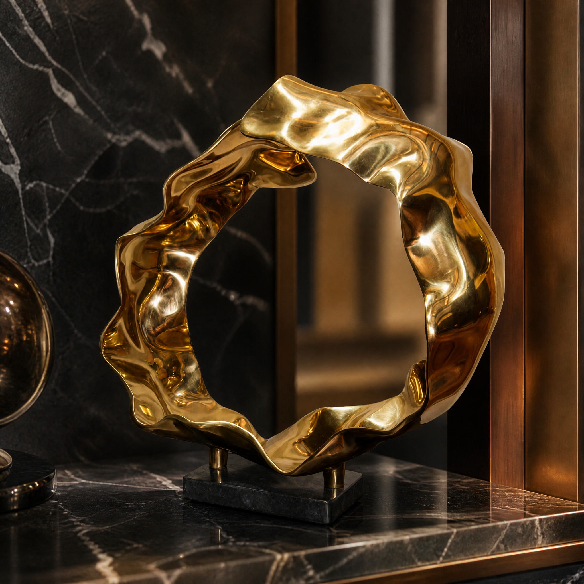 A detailed closeup showcasing the fluid lines, graceful movement, and luminous polished gold finish of the VORELLI Sartori sculpture.