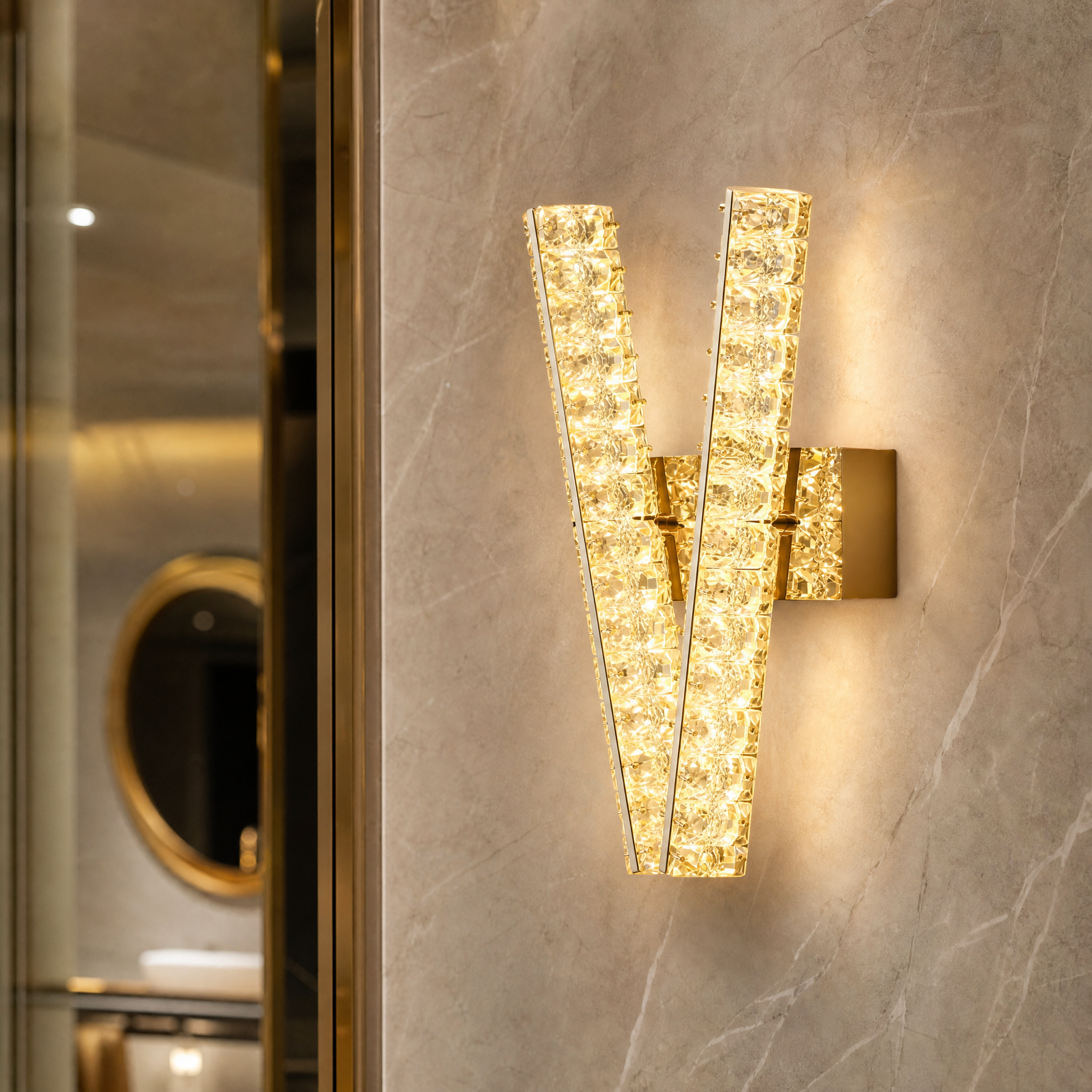 Macro closeup of the VORELLI Signature 'V' wall light, highlighting the intricate craftsmanship and brilliant clarity of the luxury diamond-cut crystals.