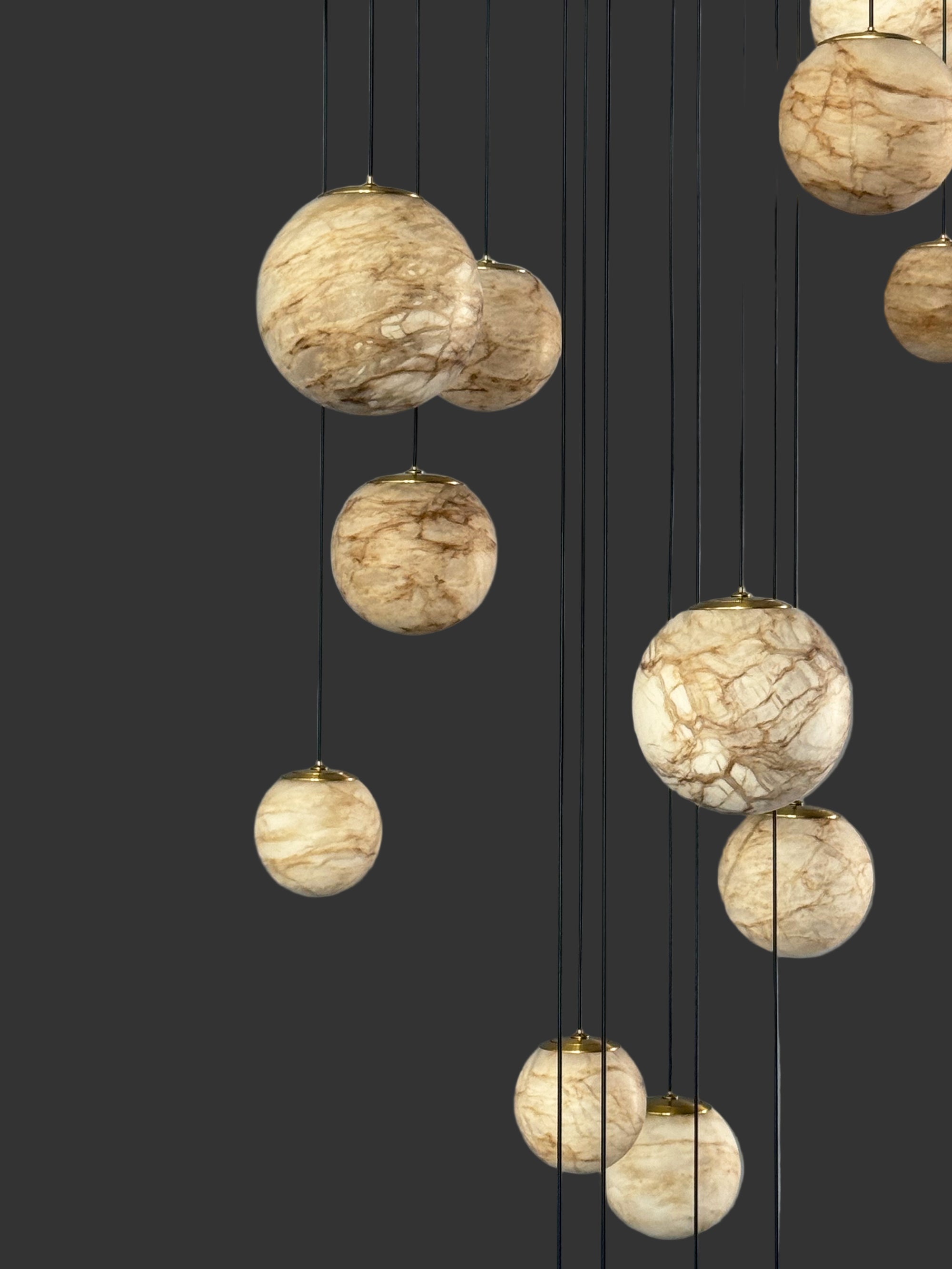 Designer VORELLI® marble chandelier with suspended glowing pendants enhancing luxury living rooms, foyers, and staircases