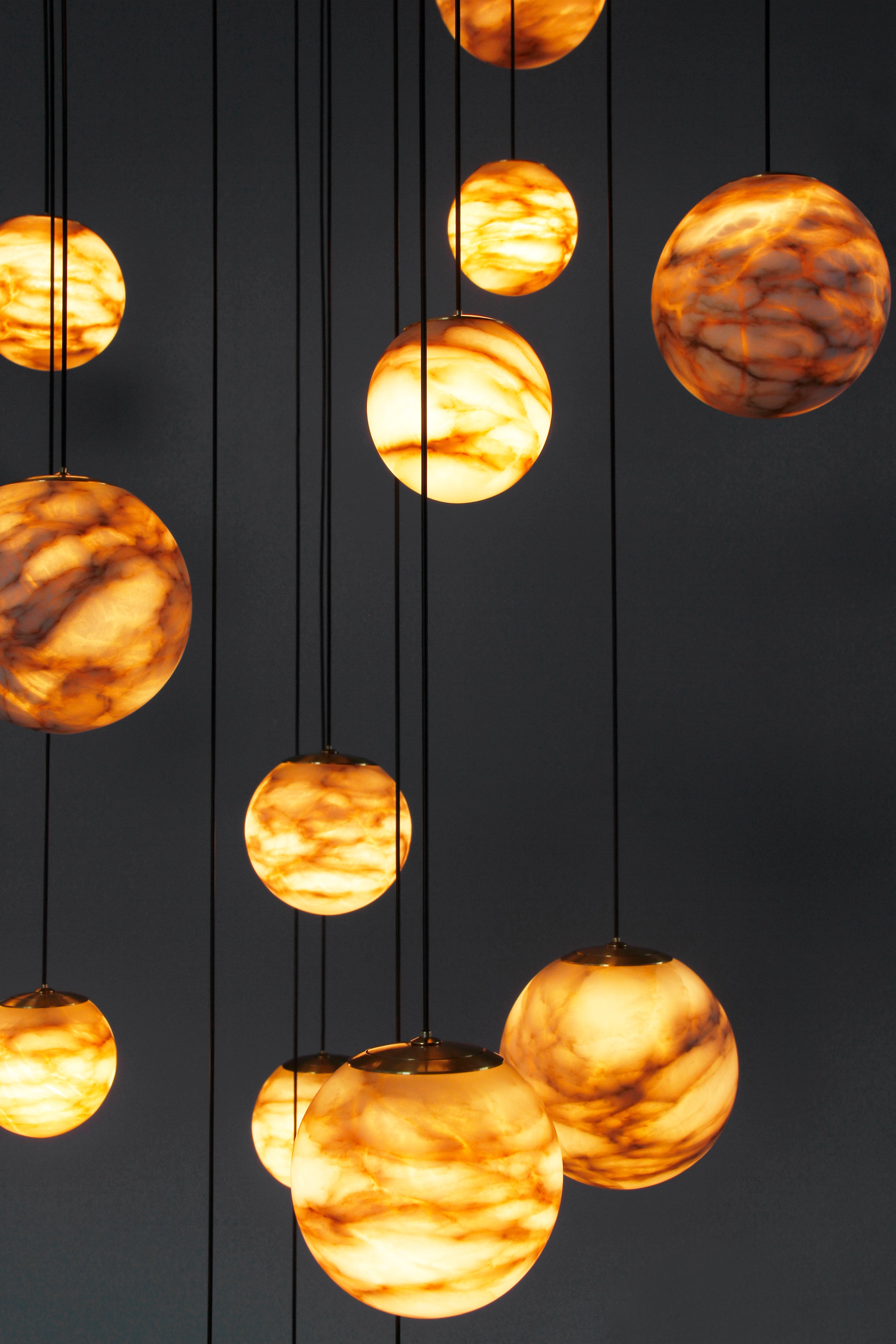 VORELLI® globe marble pendant lighting arranged vertically for dramatic staircase and double-height entrance design