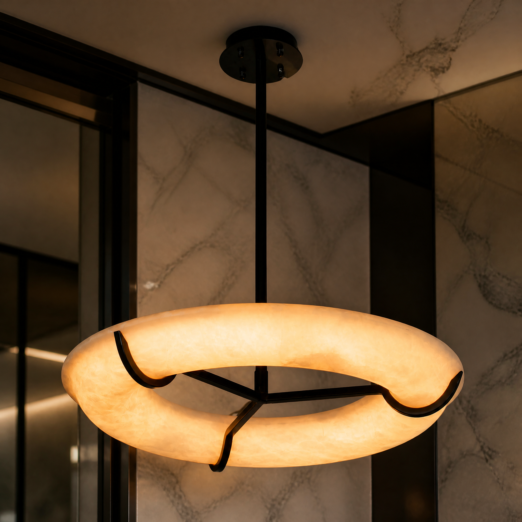 Macro closeup of the VORELLI Sorano Chandelier showcasing the premium marble texture and minimalist black suspension frame.