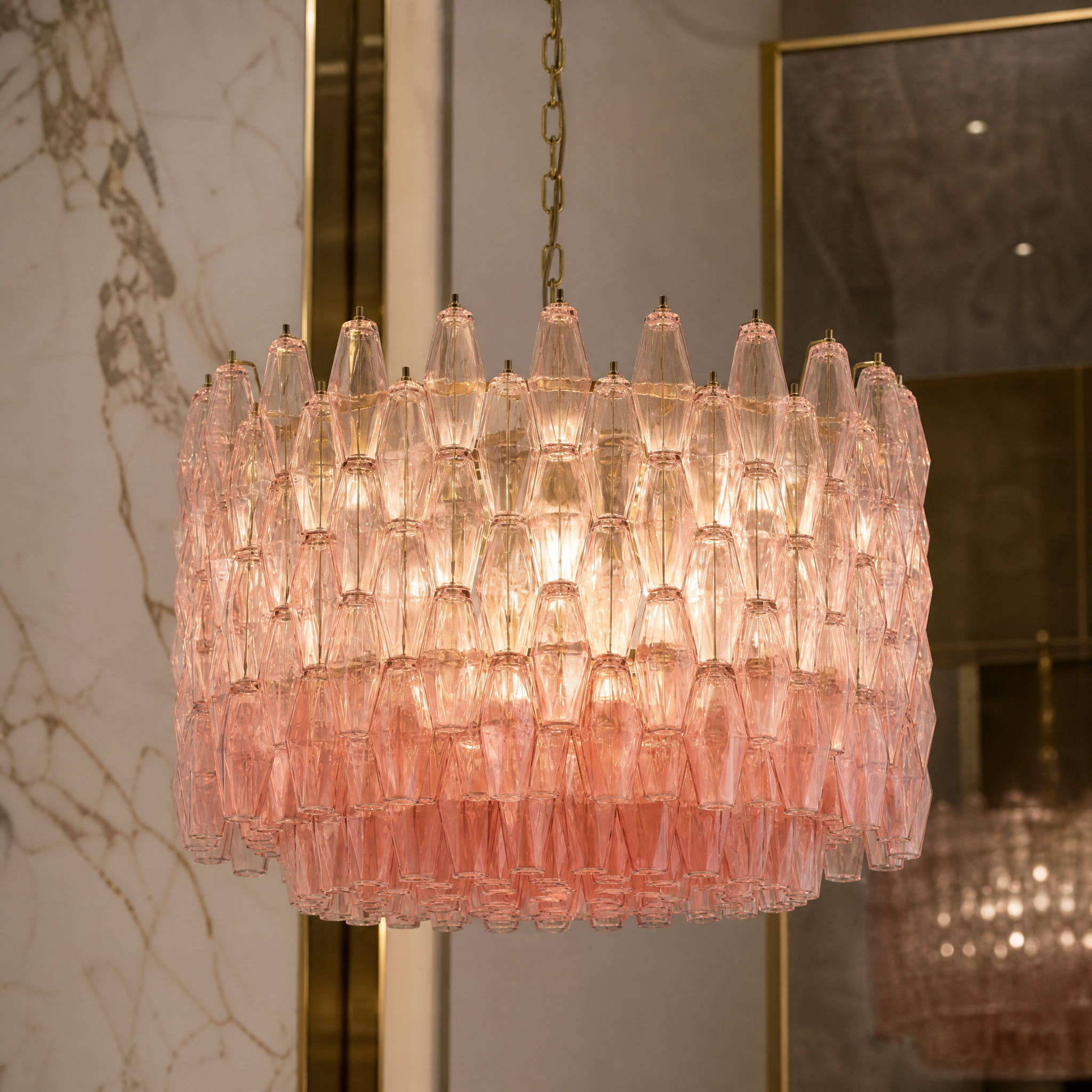 Detailed closeup of the hand-crafted pink glass polyhedrons on the VORELLI Sorrentino circular drum chandelier showcasing its vintage character.